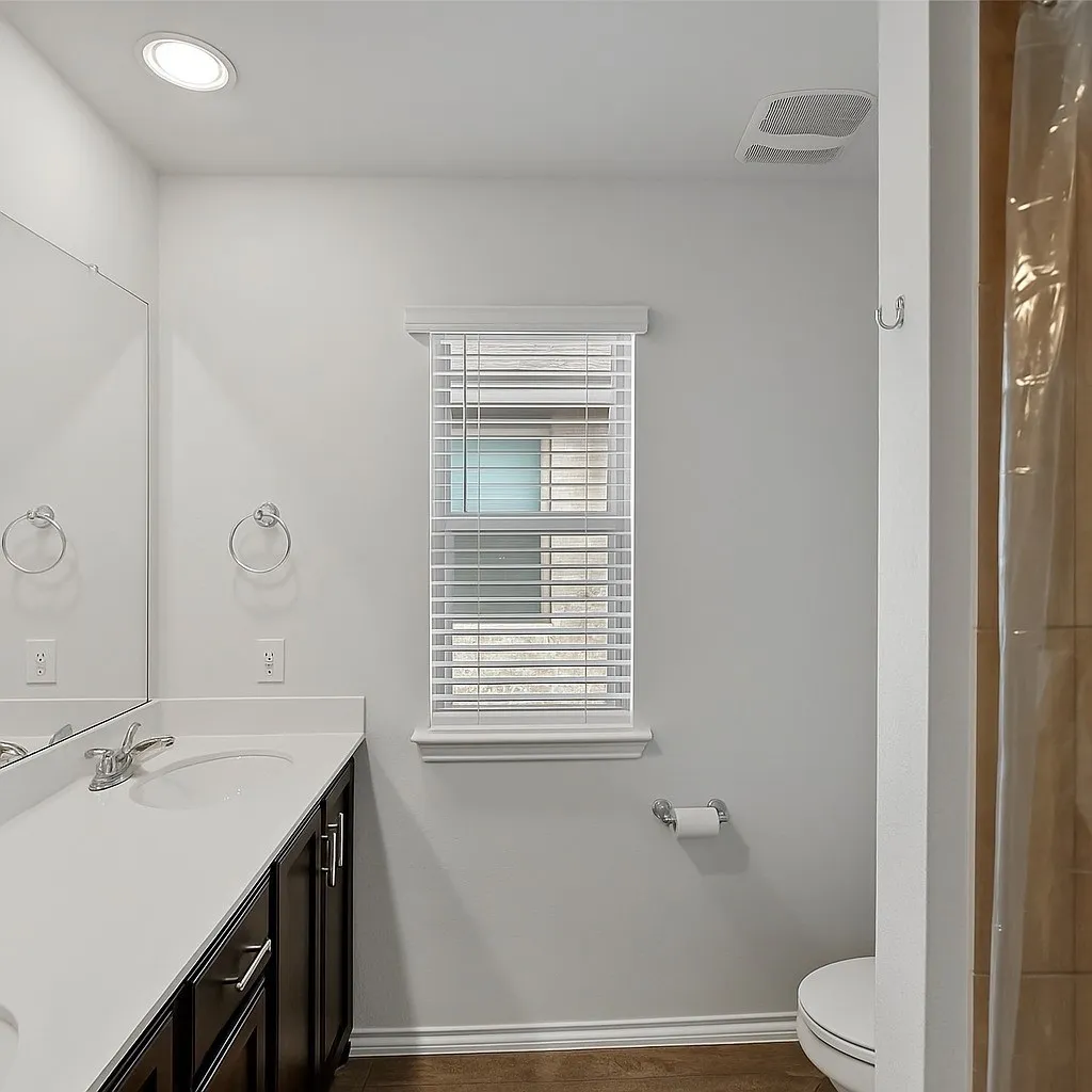 Full bath with vanity, curtained shower, and recessed lighting