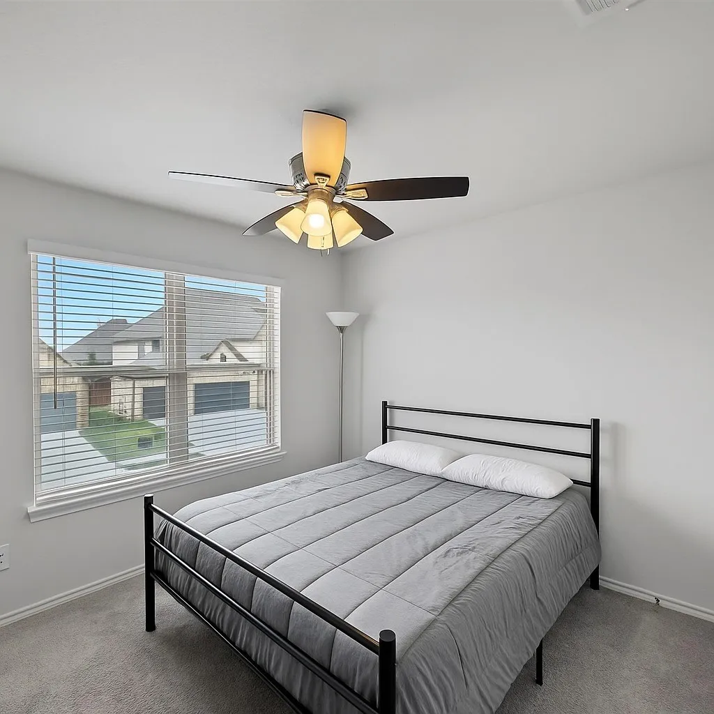 Bedroom featuring carpet flooring and a ceiling fan