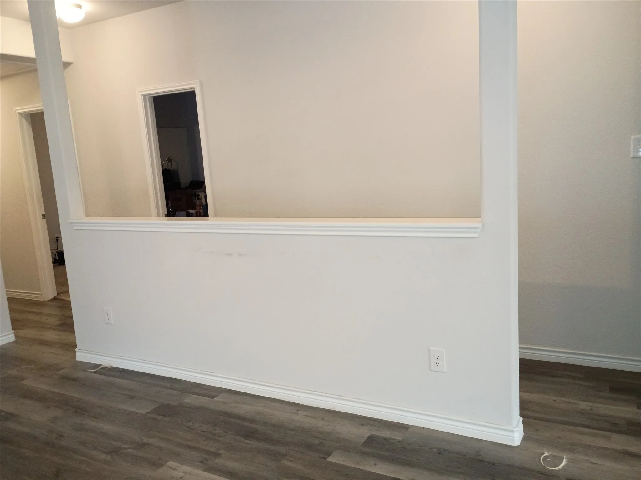 Half wall between living room and Hall allows for furniture placement and open airy feeling