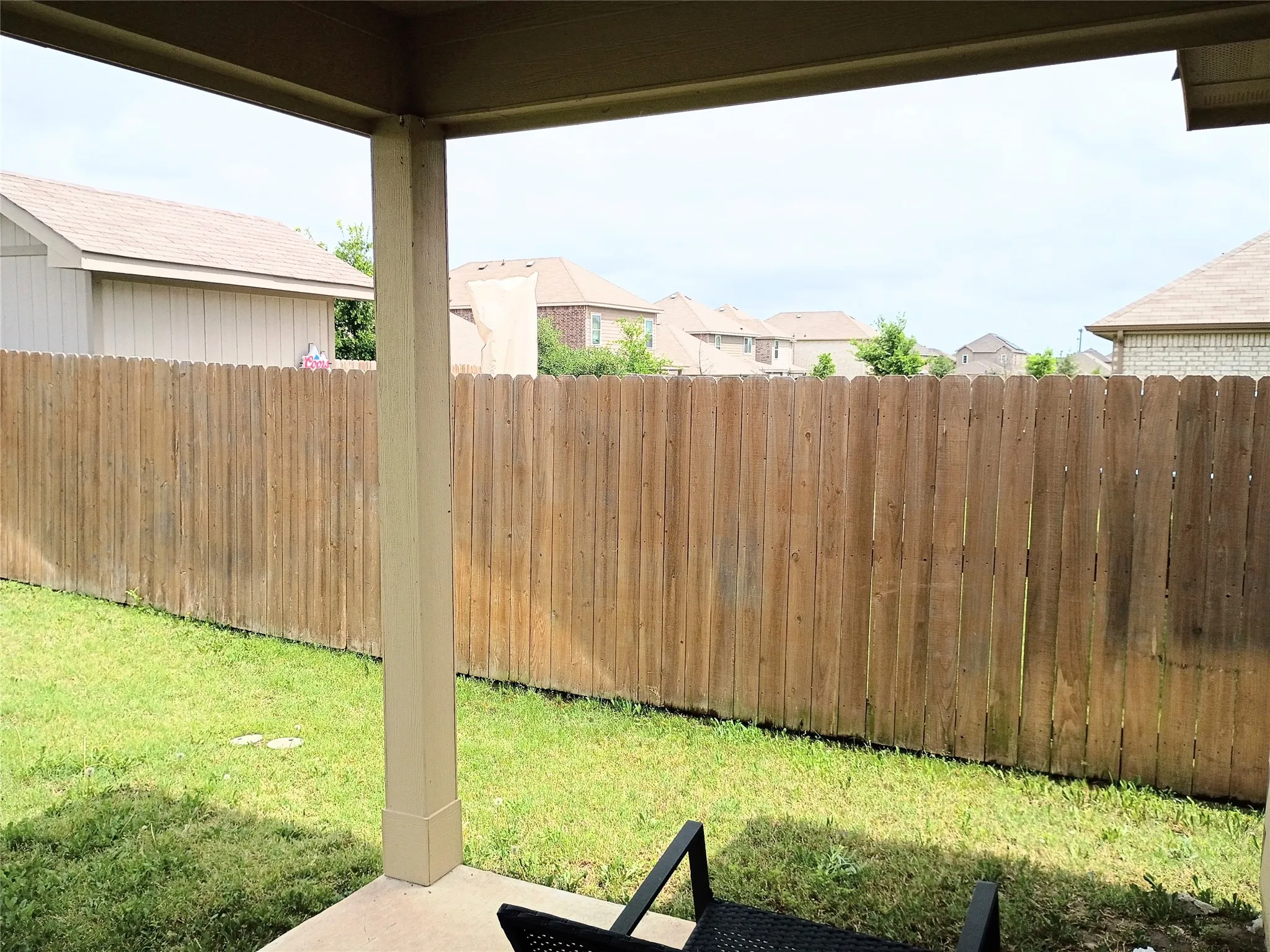 Spacious covered patio looking east. This is the narrowest part of the way backyard