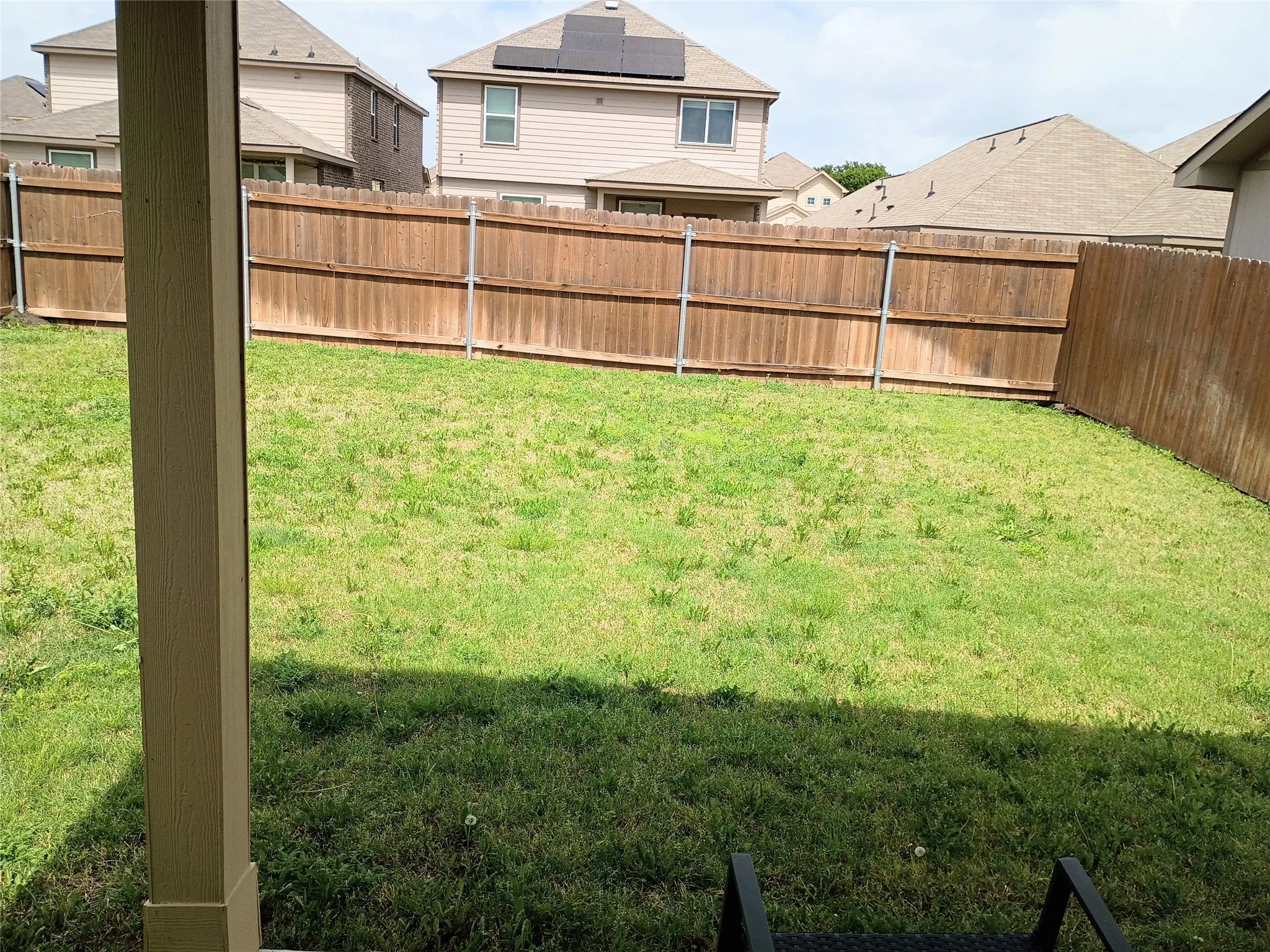 Really nice size backyard, would privacy fence with metal posts. Fence has been almost completely repainted now, it is a lighter sand color
