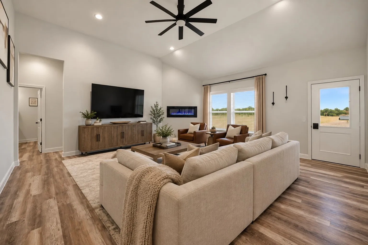 Vaulted ceiling with a black ceiling fan, recessed lighting, and wood-finish flooring