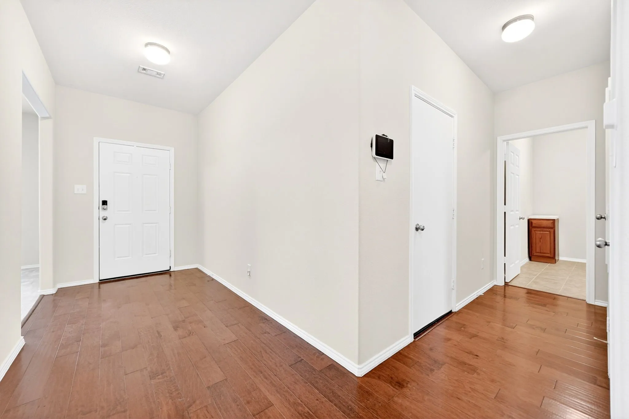 Entrance Foyer and door to garage and laundry room.