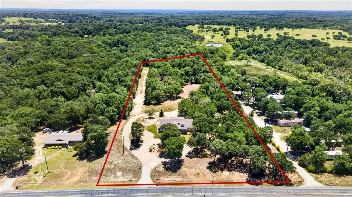 Expansive property featuring a main residence, mature trees, open land, on 9.2 acres at 11591 FM 59 Athens TX 75751 in Crossroads ISD located in Henderson county of Texas.