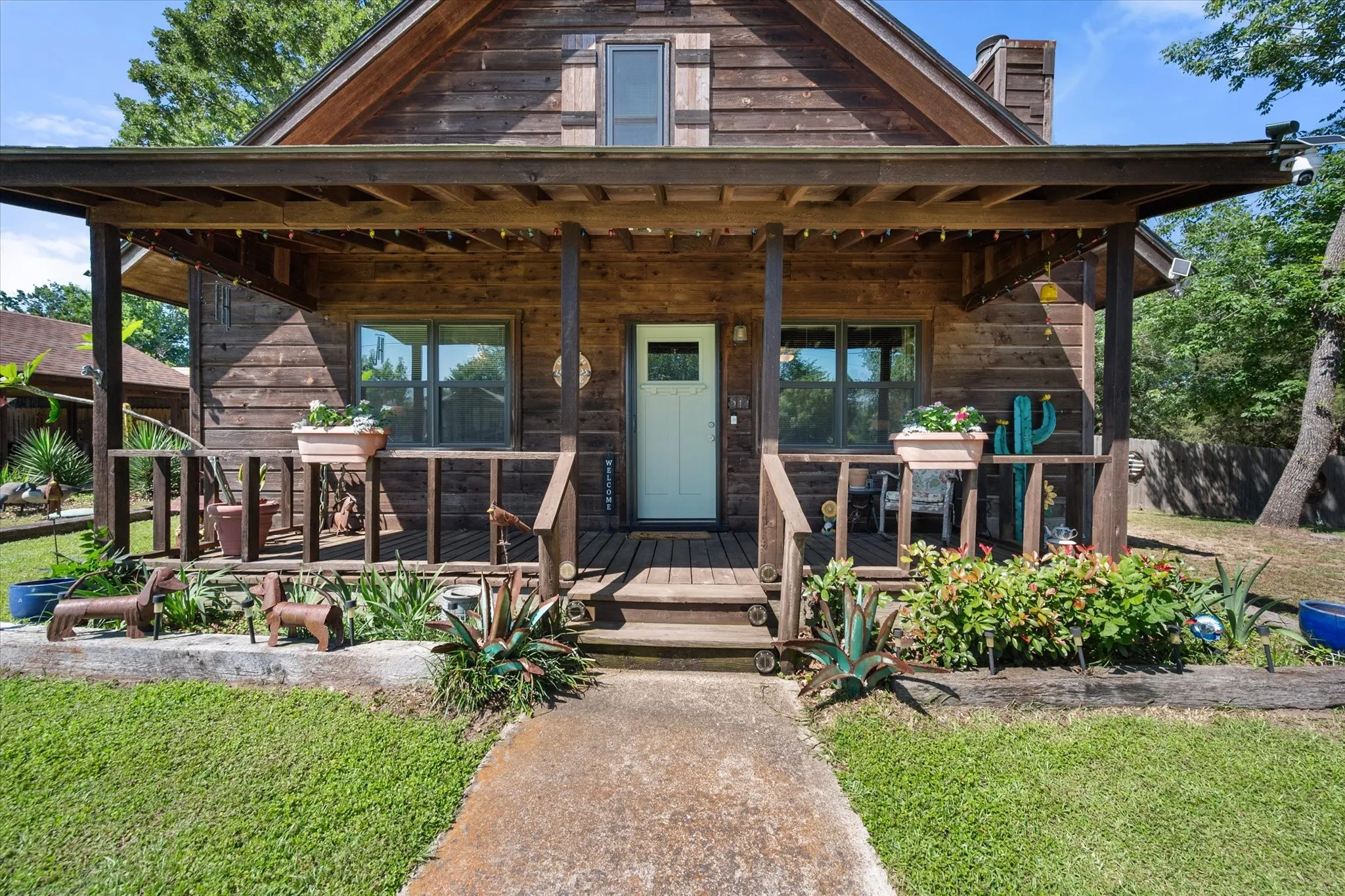 Welcoming front porch creates the perfect place to relax and enjoy the shade trees.