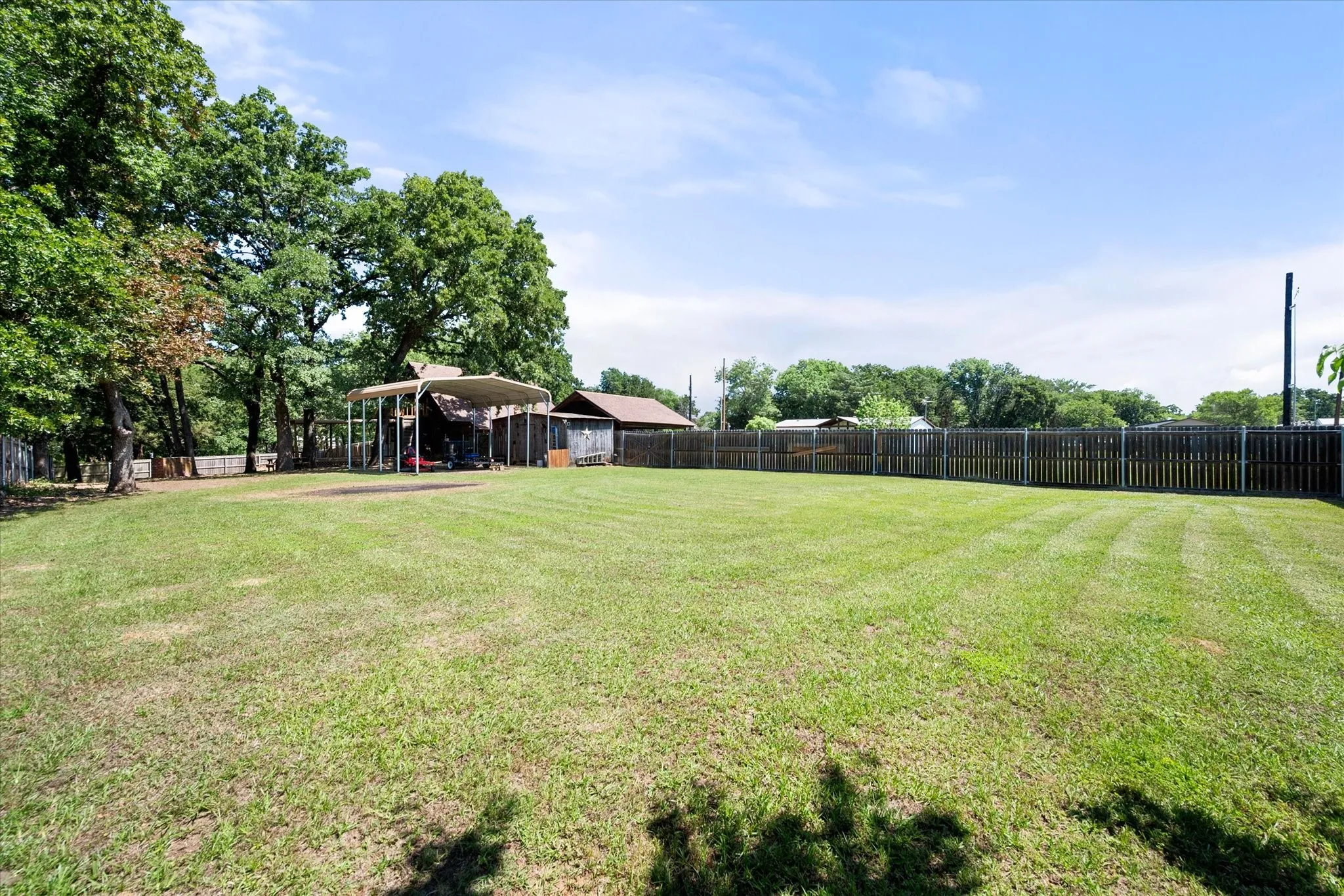 Expansive privacy-fenced backyard offers room for pets, games, and entertaining.