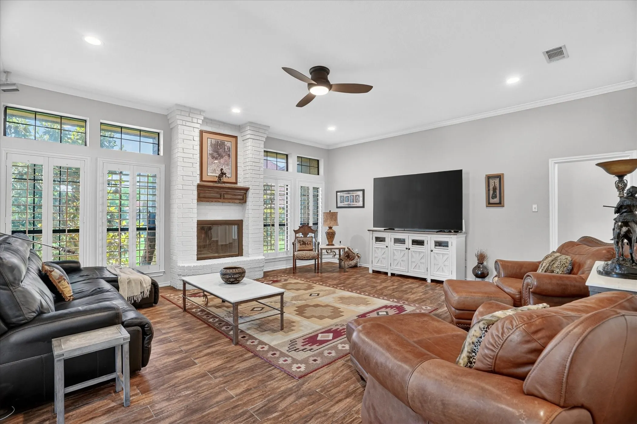Fireplace for cozy seating and ample sunlight.