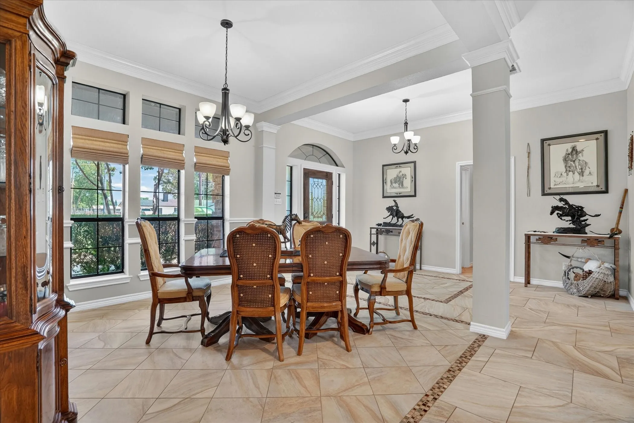 Formal dining area with decorative lighting.