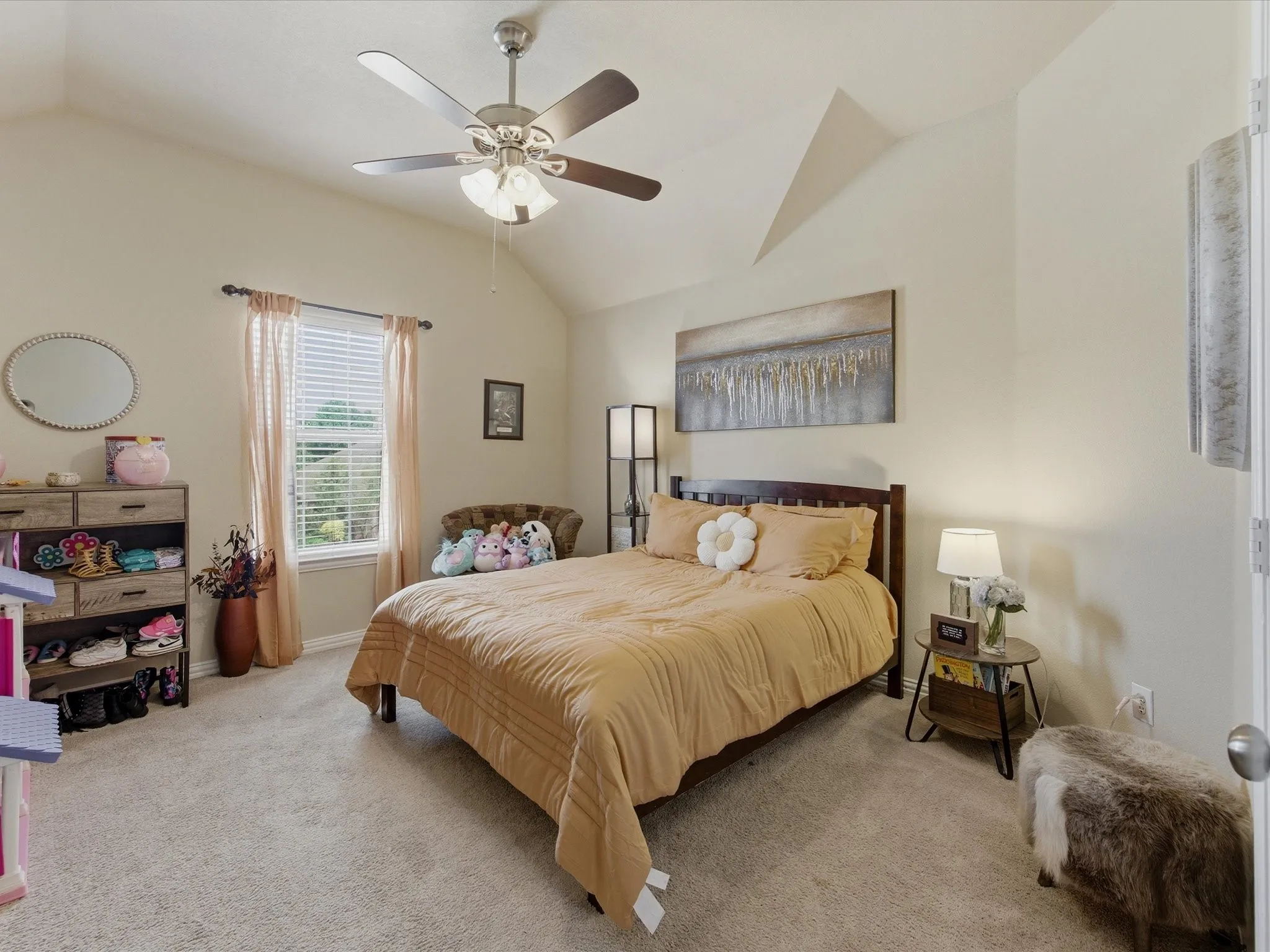 Vaulted ceiling bedroom featuring light-toned carpeting, a window with blinds, and a ceiling fan with integrated lighting