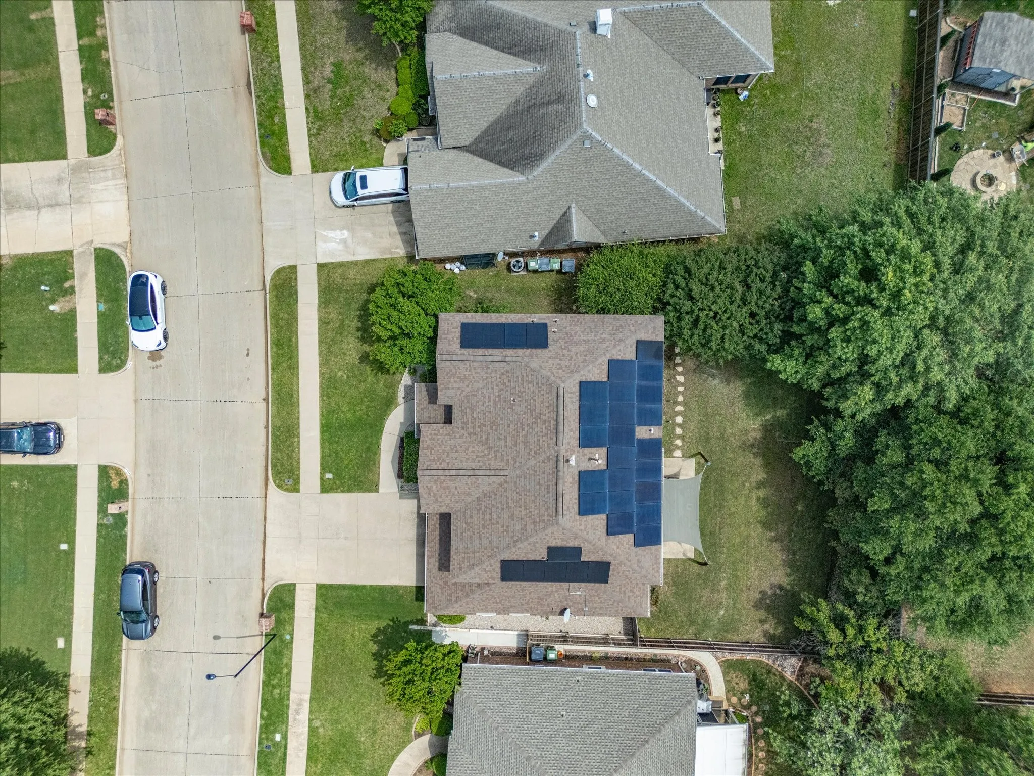 Aerial perspective highlighting a residential property with extensive rooftop solar paneling