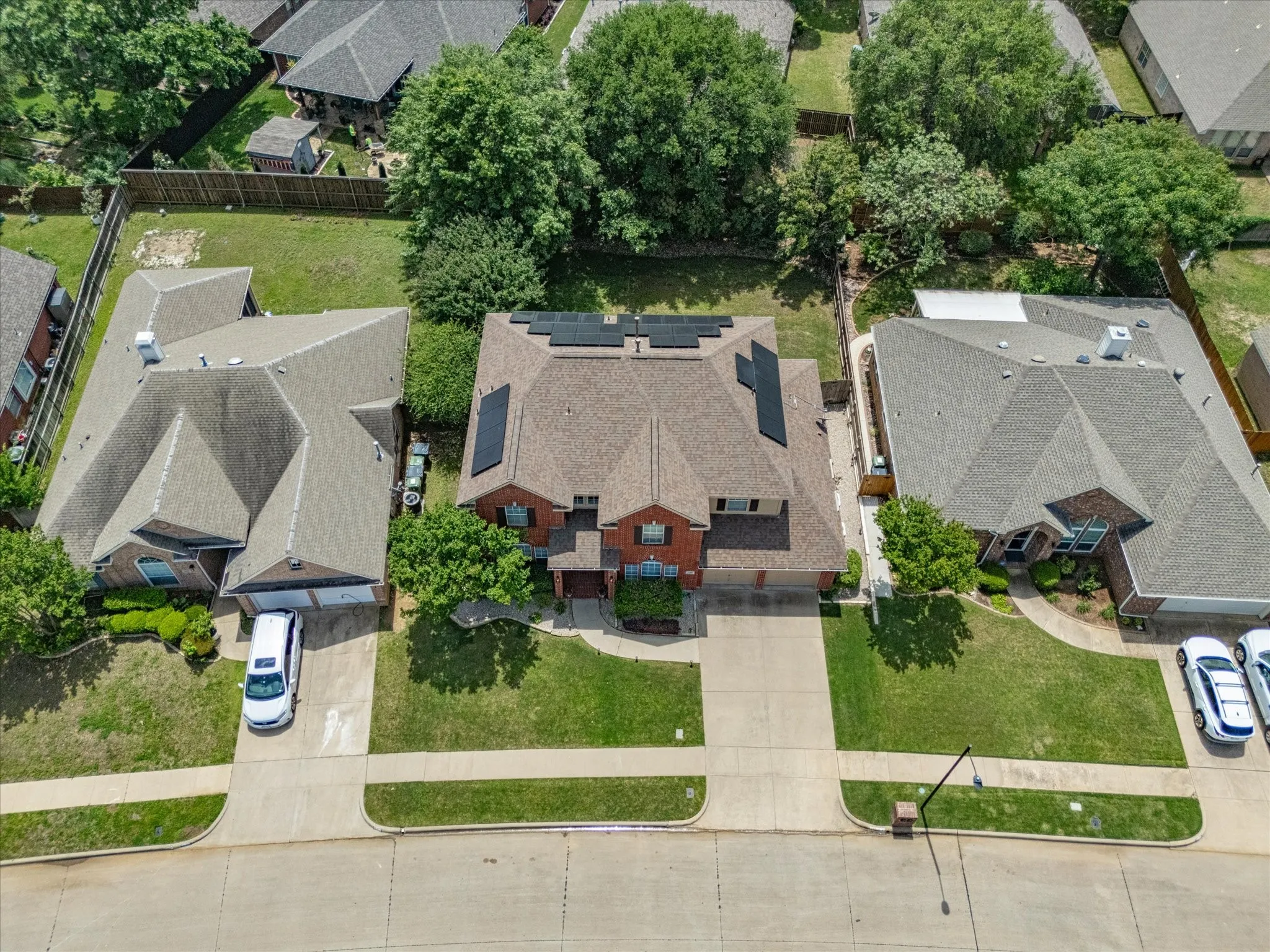 Traditional brick exterior residence featuring a gabled roofline and integrated solar panels