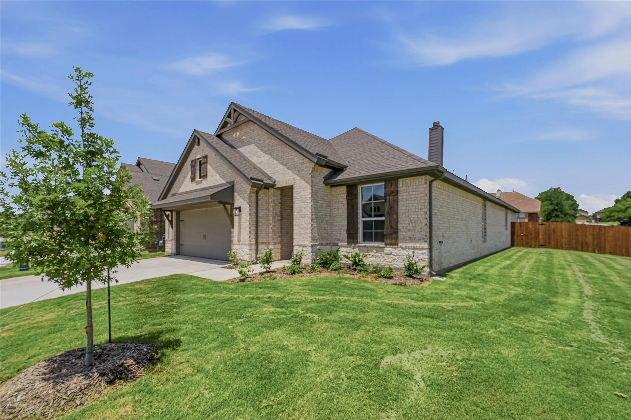 Light-colored brick exterior featuring stone accents and dark brown trim