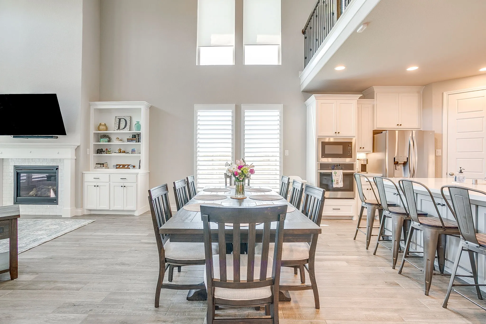 The dining area is spacious, inviting, and filled with natural light from the surrounding walls of windows!