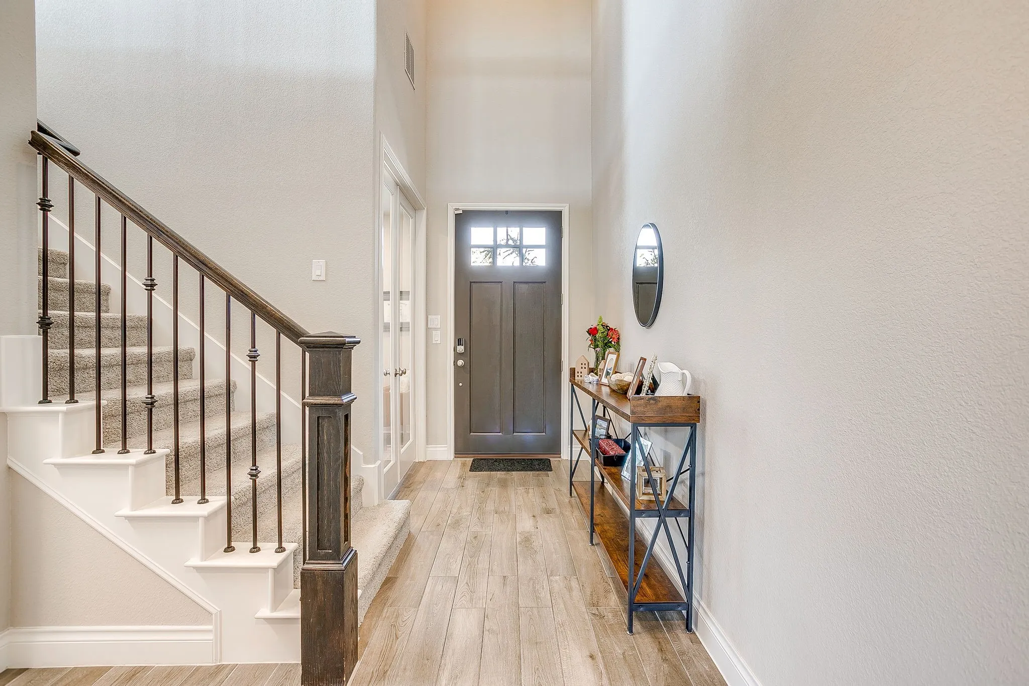 Step inside to a light-filled interior featuring beautiful wood-look tile flooring throughout the main living areas.
