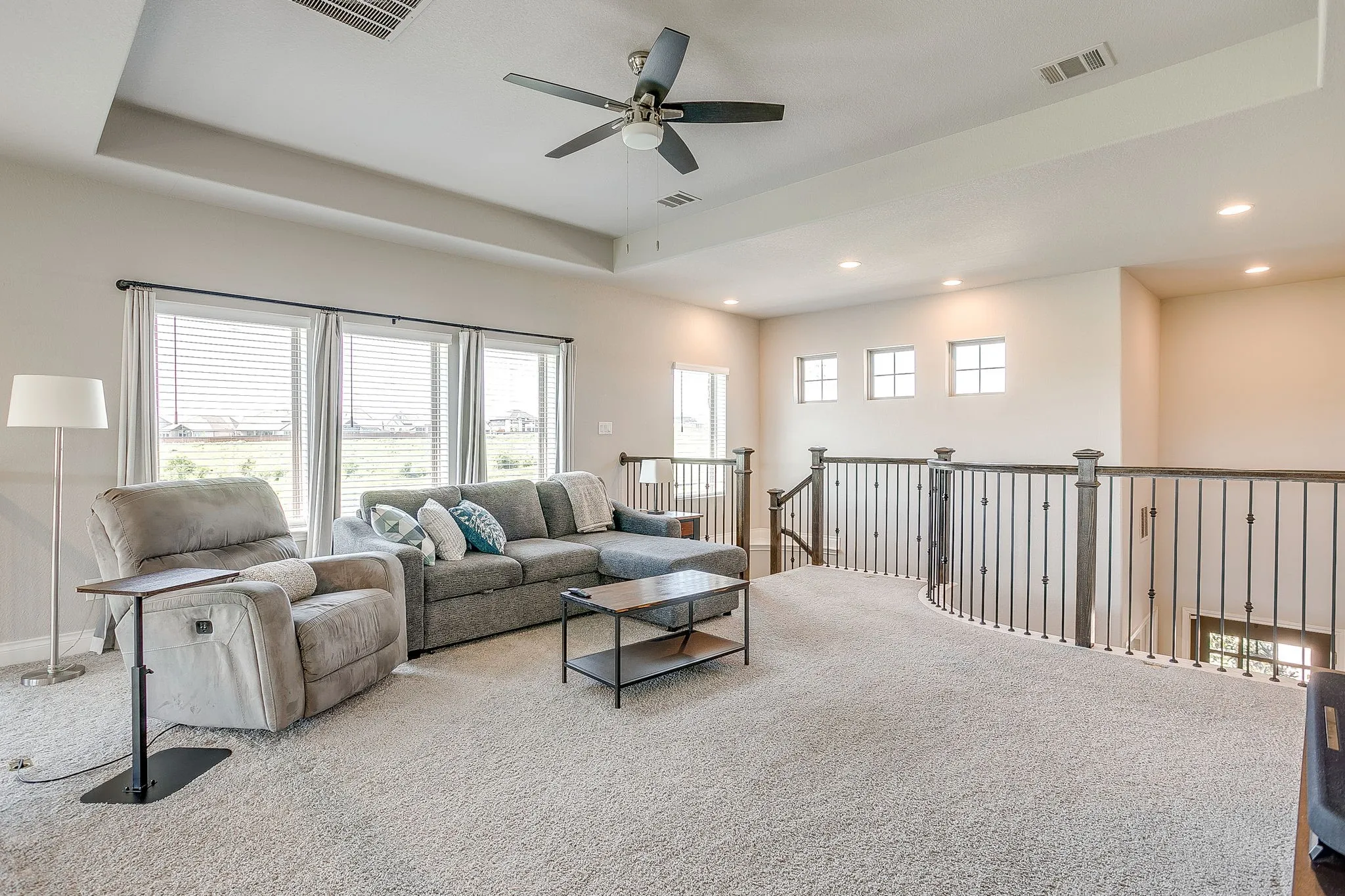 Another view of the loft area showcasing the beautiful wrought iron and wood railings! Tons of natural light again!
