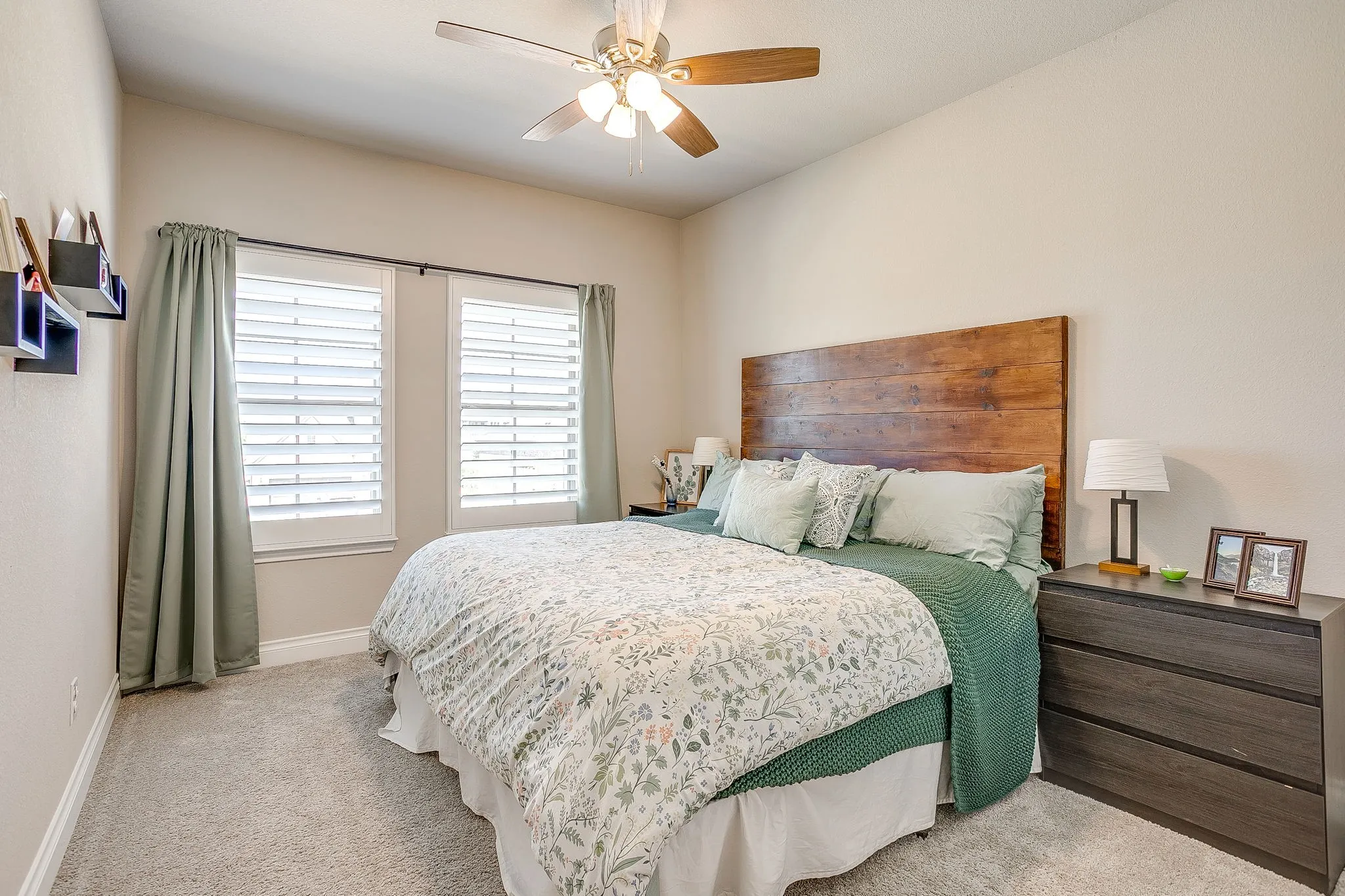 The first of two spacious upstairs bedrooms — bright and airy with large windows and beautiful plantation shutters!
