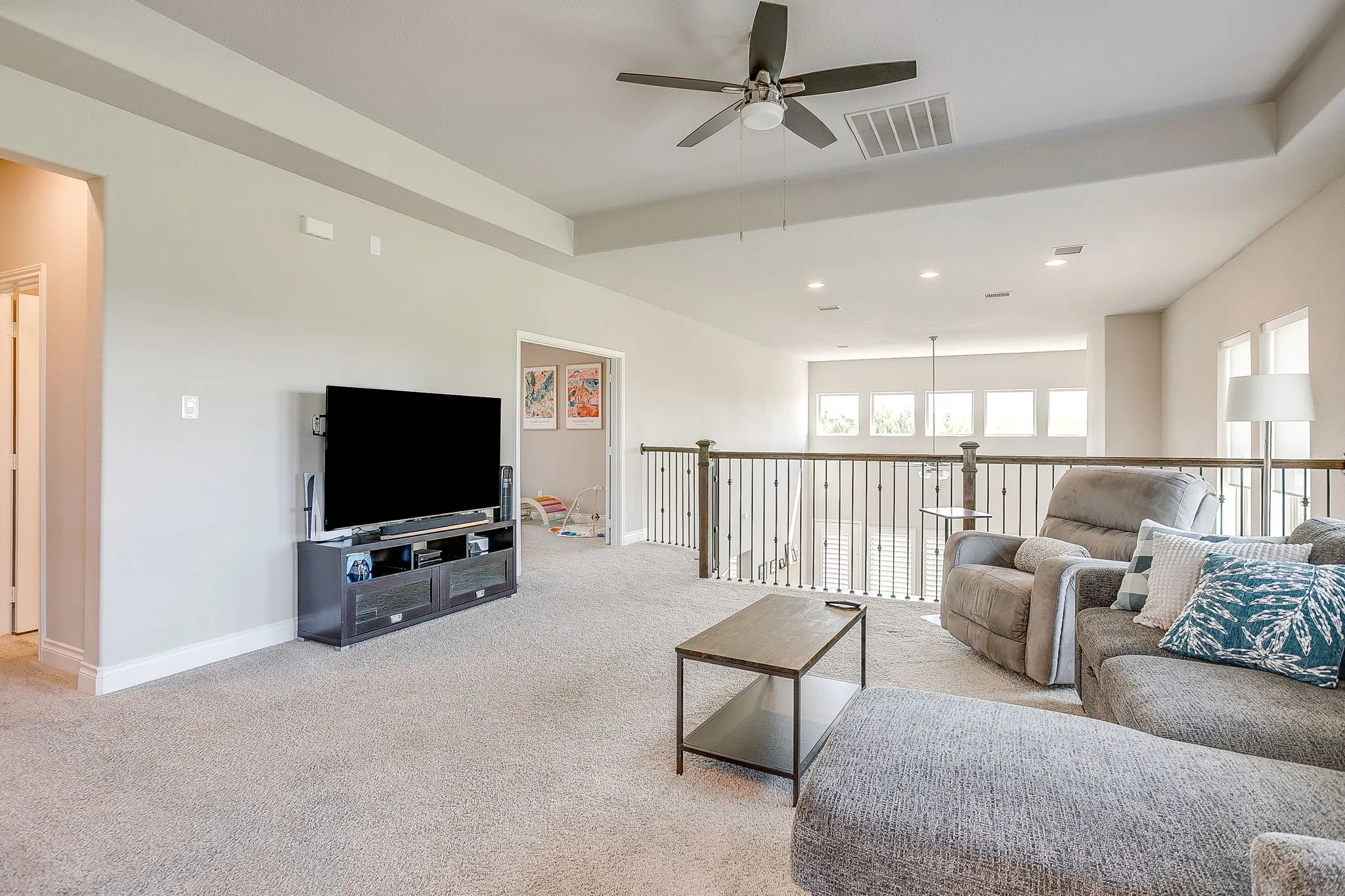 Upstairs is another spacious living area overlooking the main living space downstairs — the perfect spot for family and kids to relax, chill, and play!