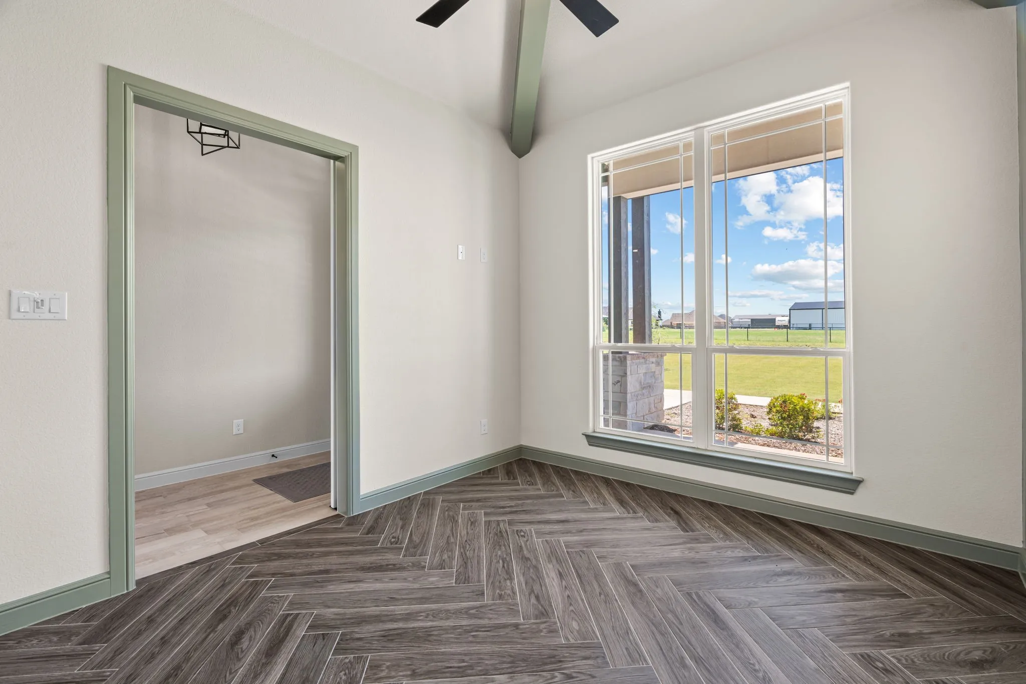 Great View of the Wood-Look Tile Floors, Ceiling Fan & Natural Light