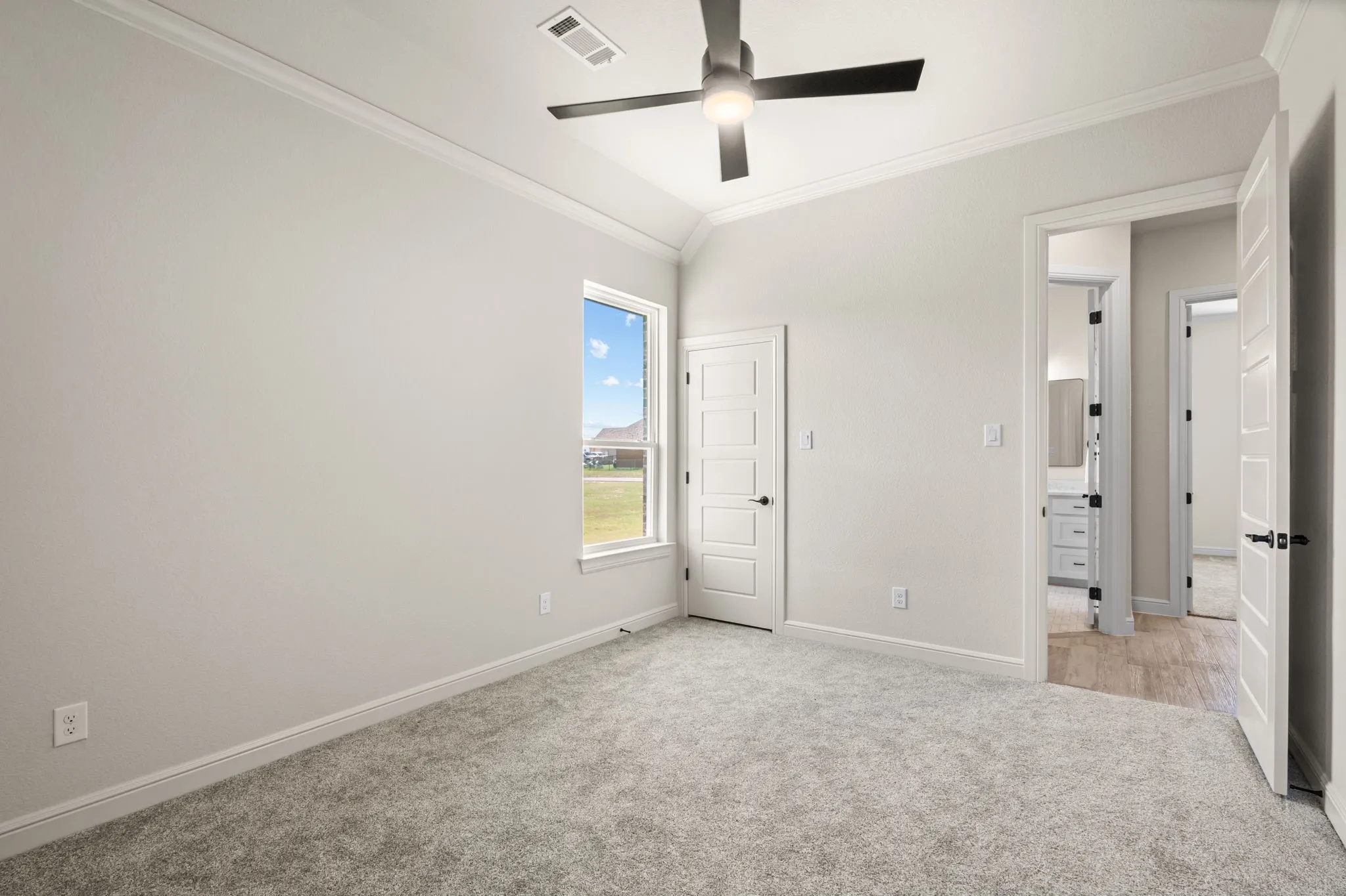 Guest Bedroom has Carpet, Ceiling Fan & Deep Walk-In Closet
