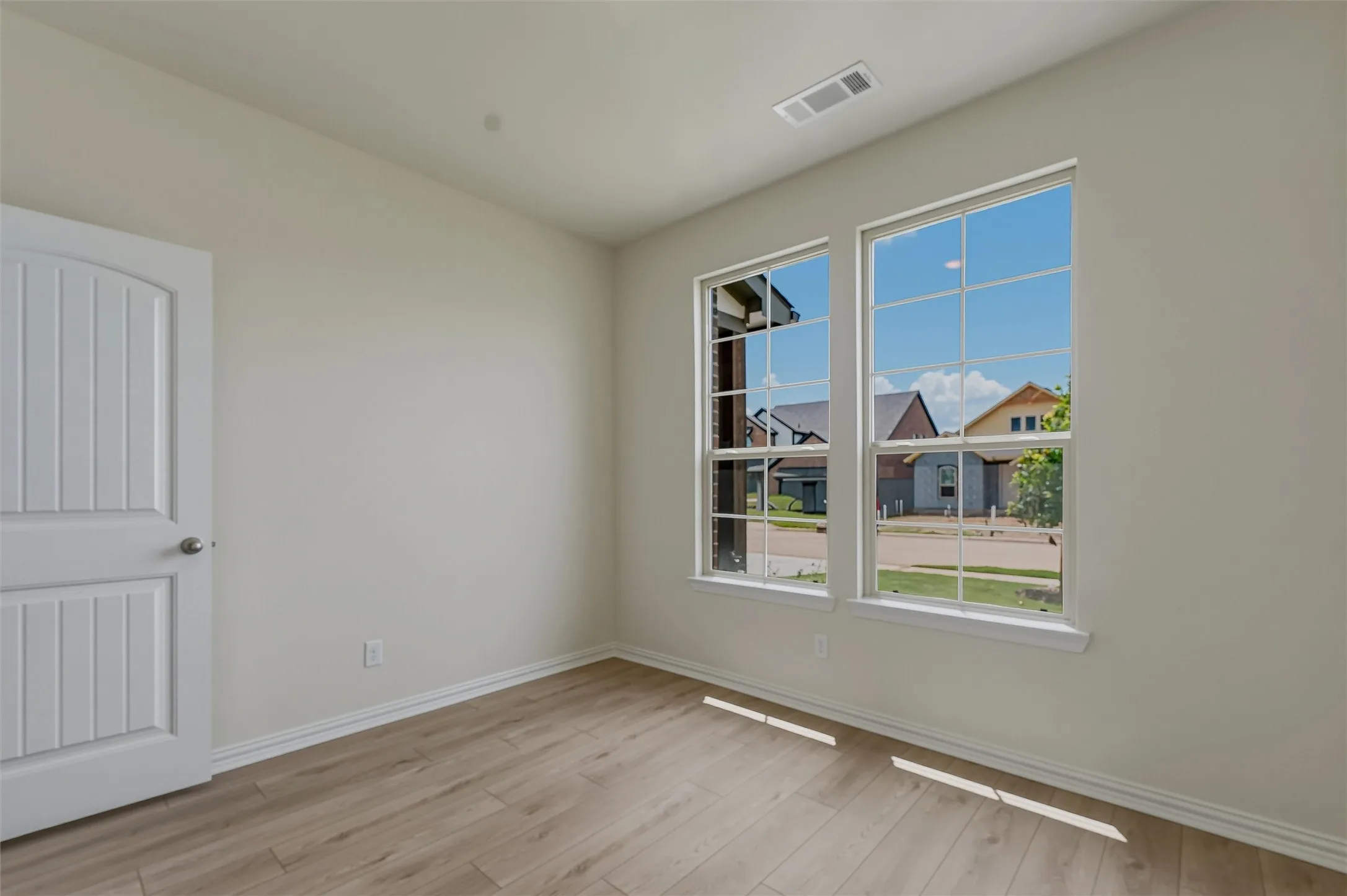 Neutral tone walls with wood-finish flooring