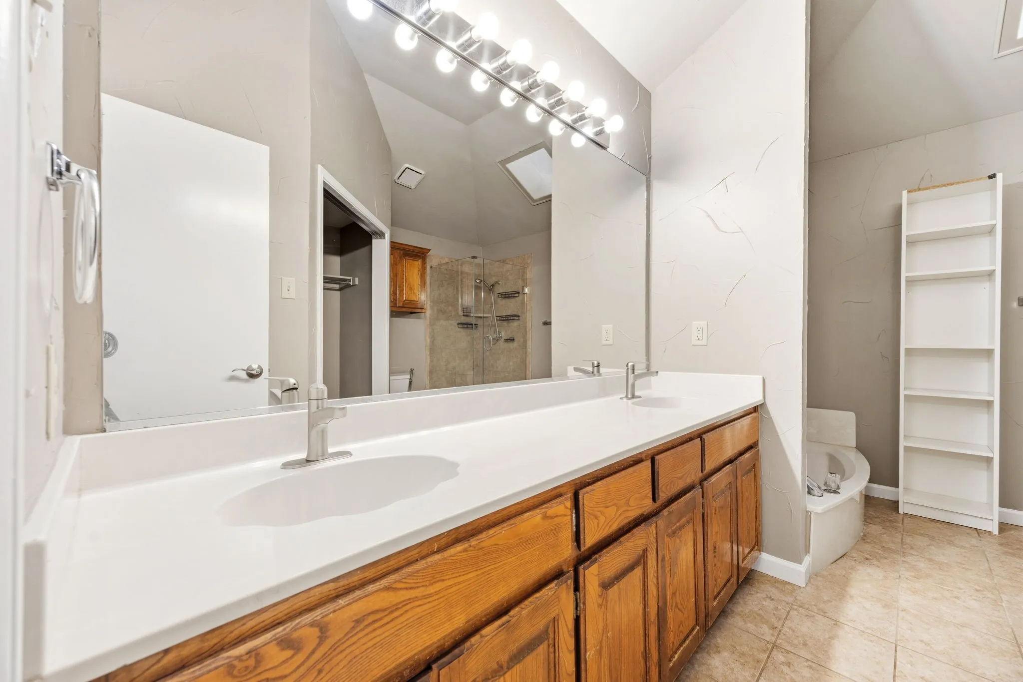 The primary bathroom vanity at 2060 Arbor Creek Drive #B, Carrollton, Texas.