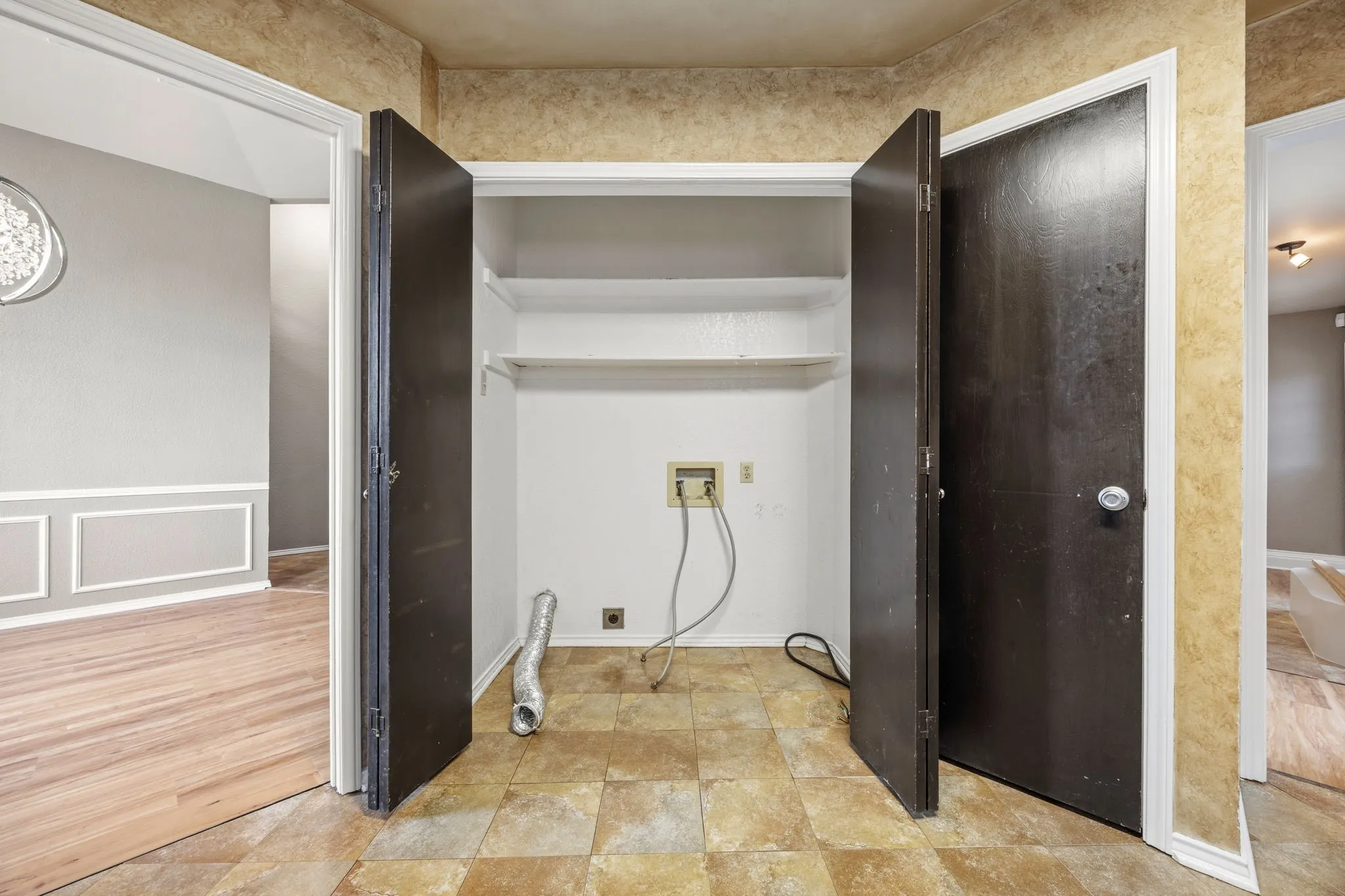 The laundry room at 2060 Arbor Creek Drive #B, an indoor laundry room buyers searching Carrollton, TX homes for sale specifically look for.