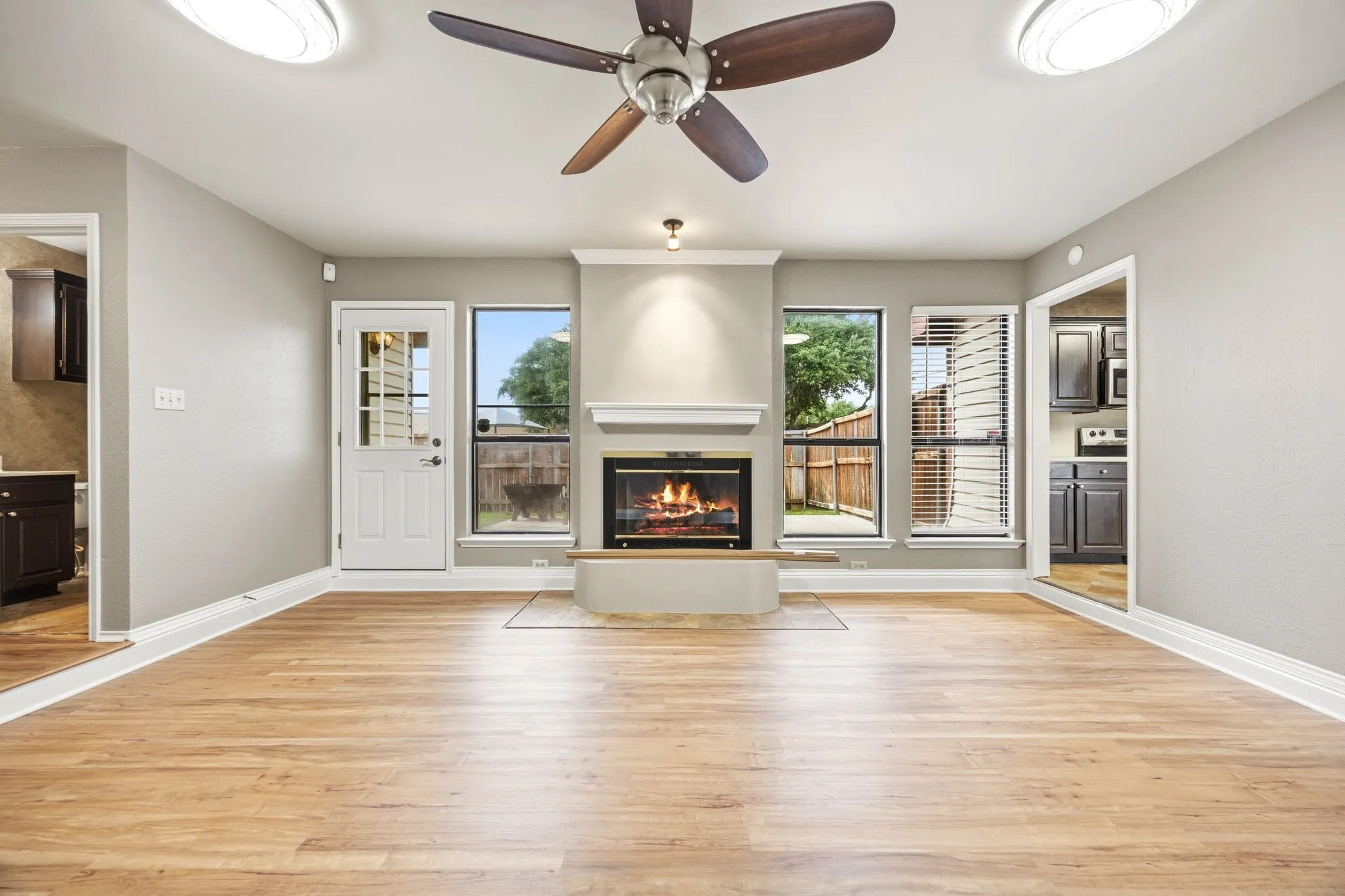 The living room at 2060 Arbor Creek Drive #B, with the wood burning fireplace that buyers searching for Carrollton, TX homes with a fireplace ask about first.