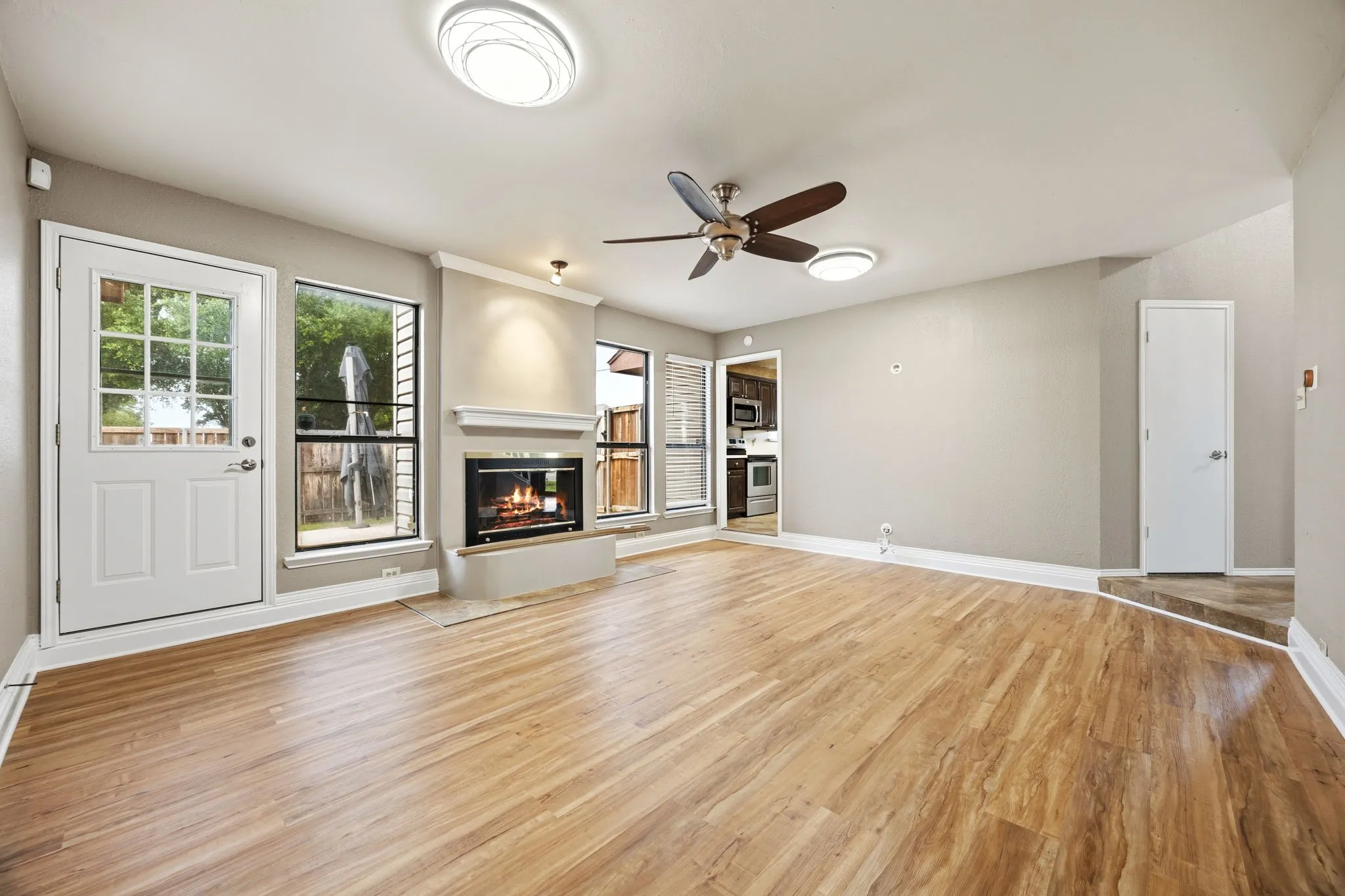 A second angle of the living room at 2060 Arbor Creek Drive #B, showing the natural light buyers want in Carrollton, TX homes for sale.