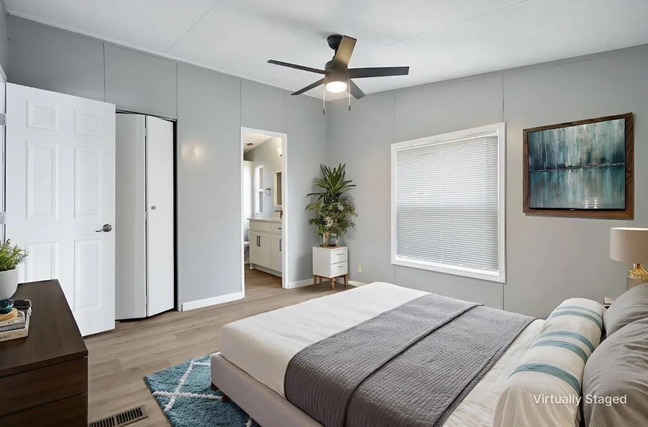 Light gray walls define this room featuring wood-finish flooring