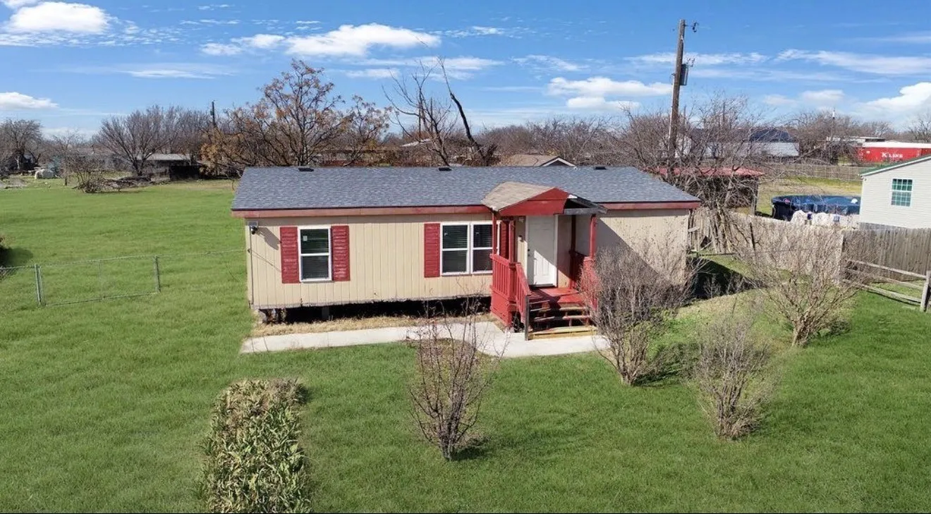 Exterior featuring a covered porch with red railings, light-colored siding, and a dark shingle roof
