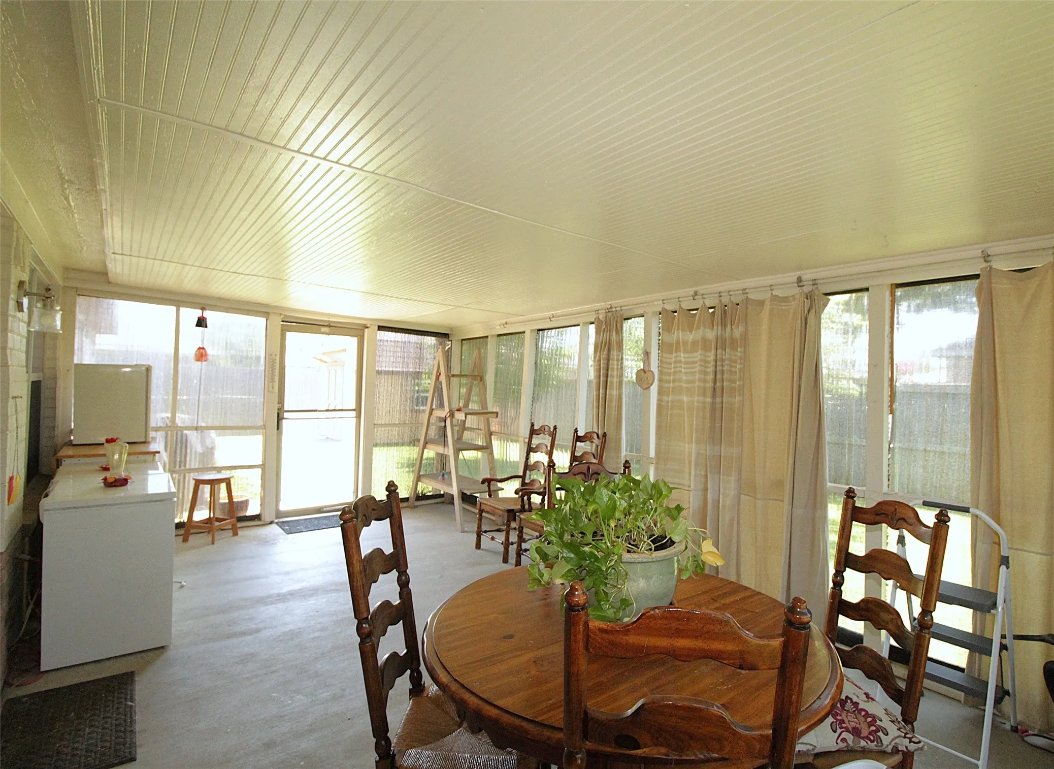 Back Patio has panels that are removable. It has screen underneath to let in a breeze.