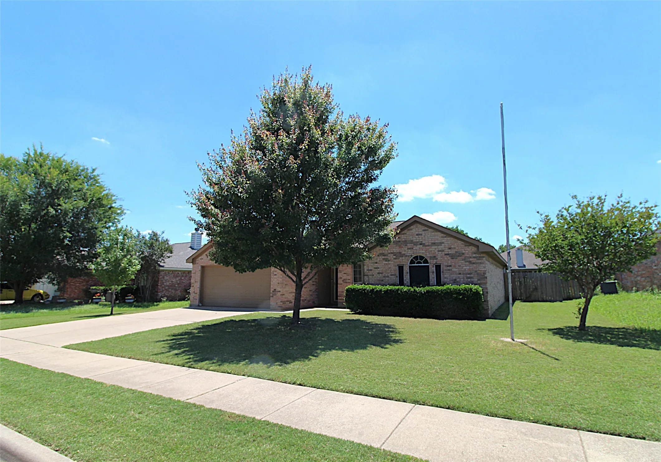 Street view of the home and flag pole.