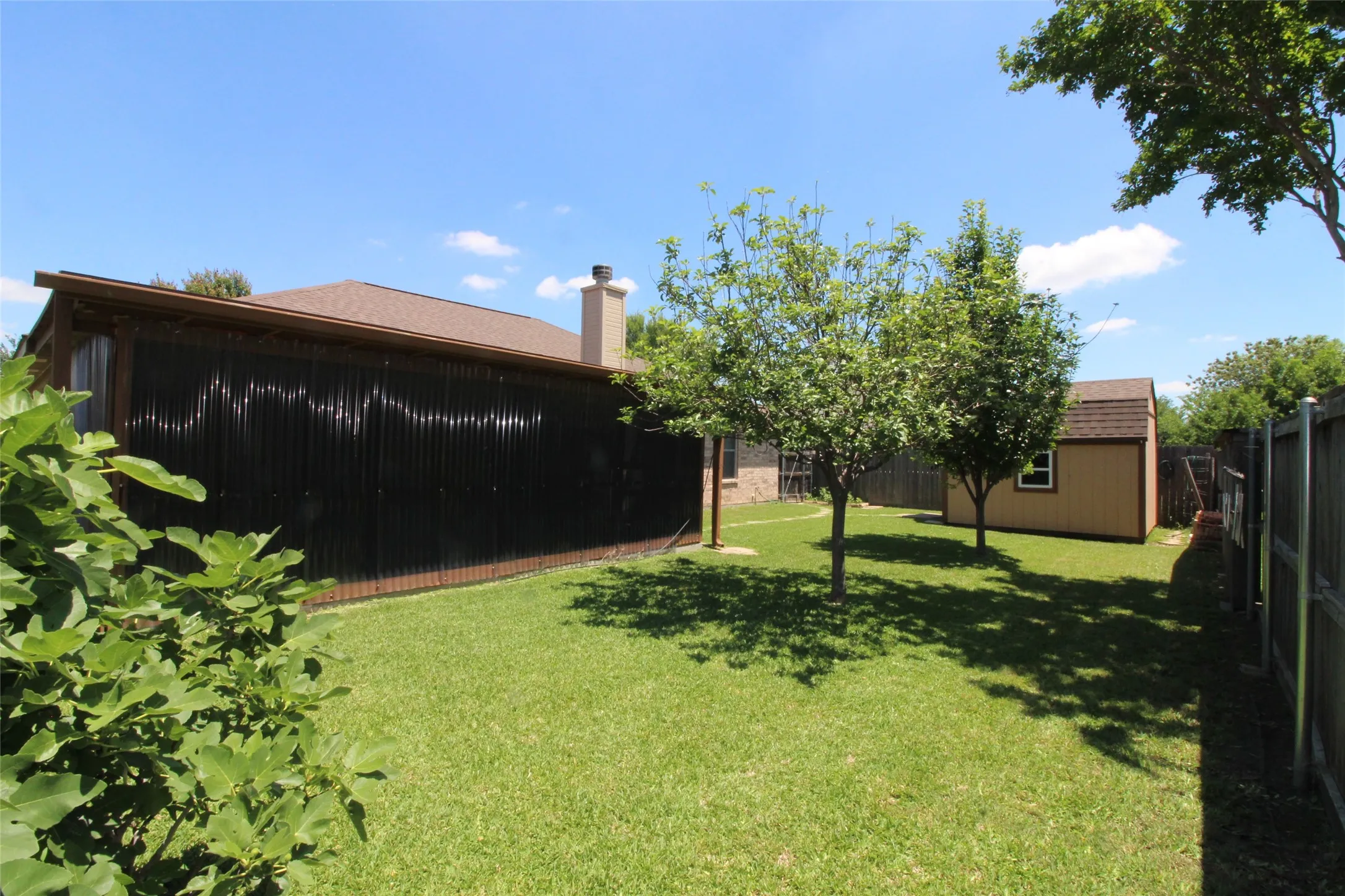 Backyard view of patio. The panels are clear and it is shady.