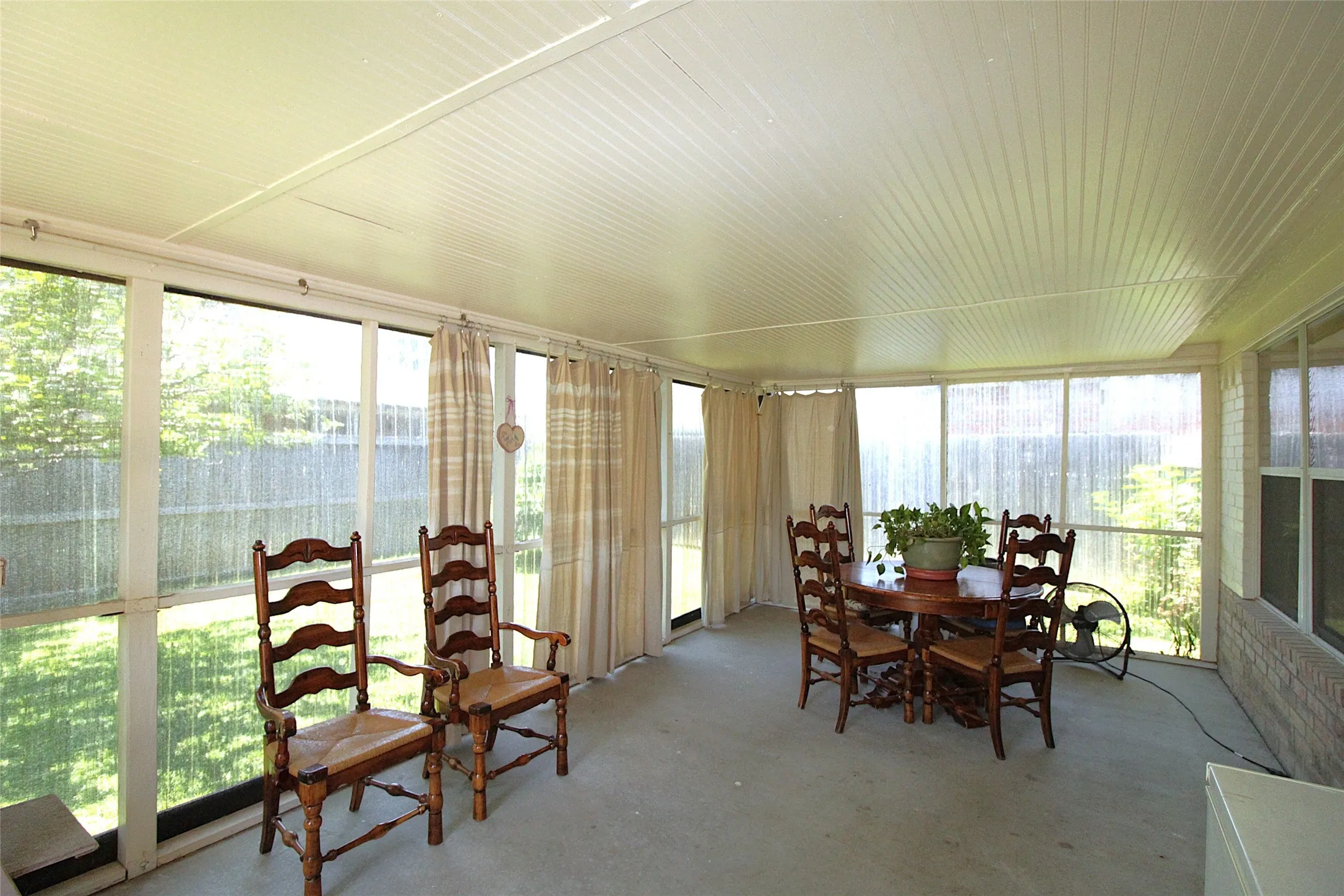 The Back Patio is covered, enclosed & screened in back patio is roomy and full of light.