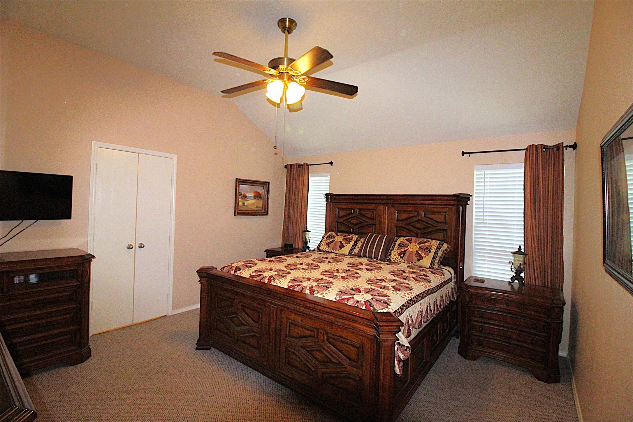 Primary Bedroom fits this King Sized bed & nightstand, vanity & chest of drawers.