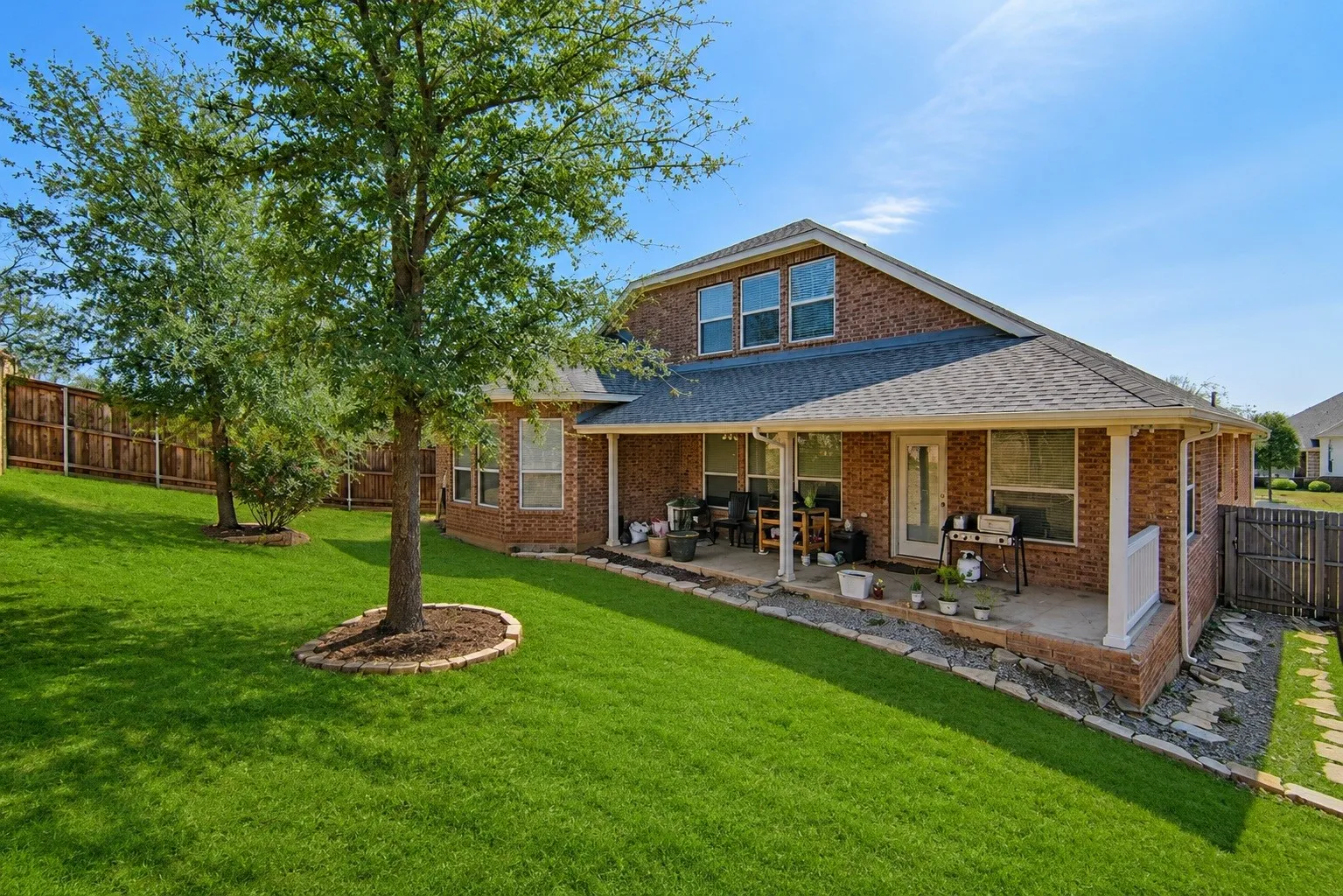 Expansive green lawn with mature trees