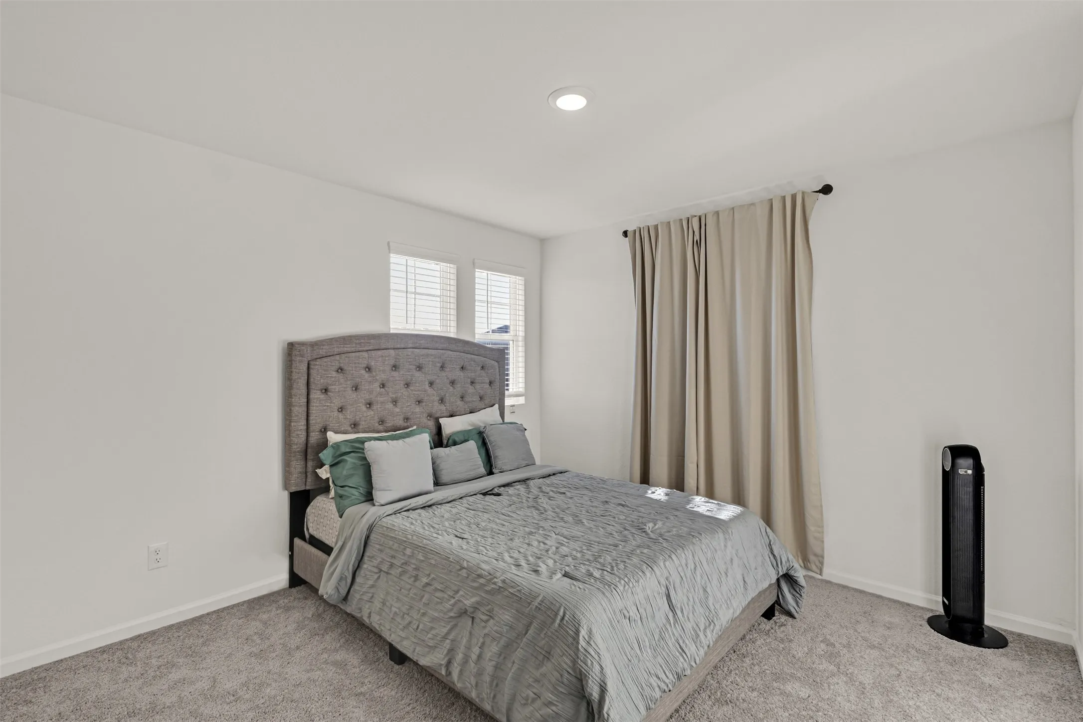 Bedroom featuring light gray carpeting, neutral wall paint, and recessed ceiling lighting