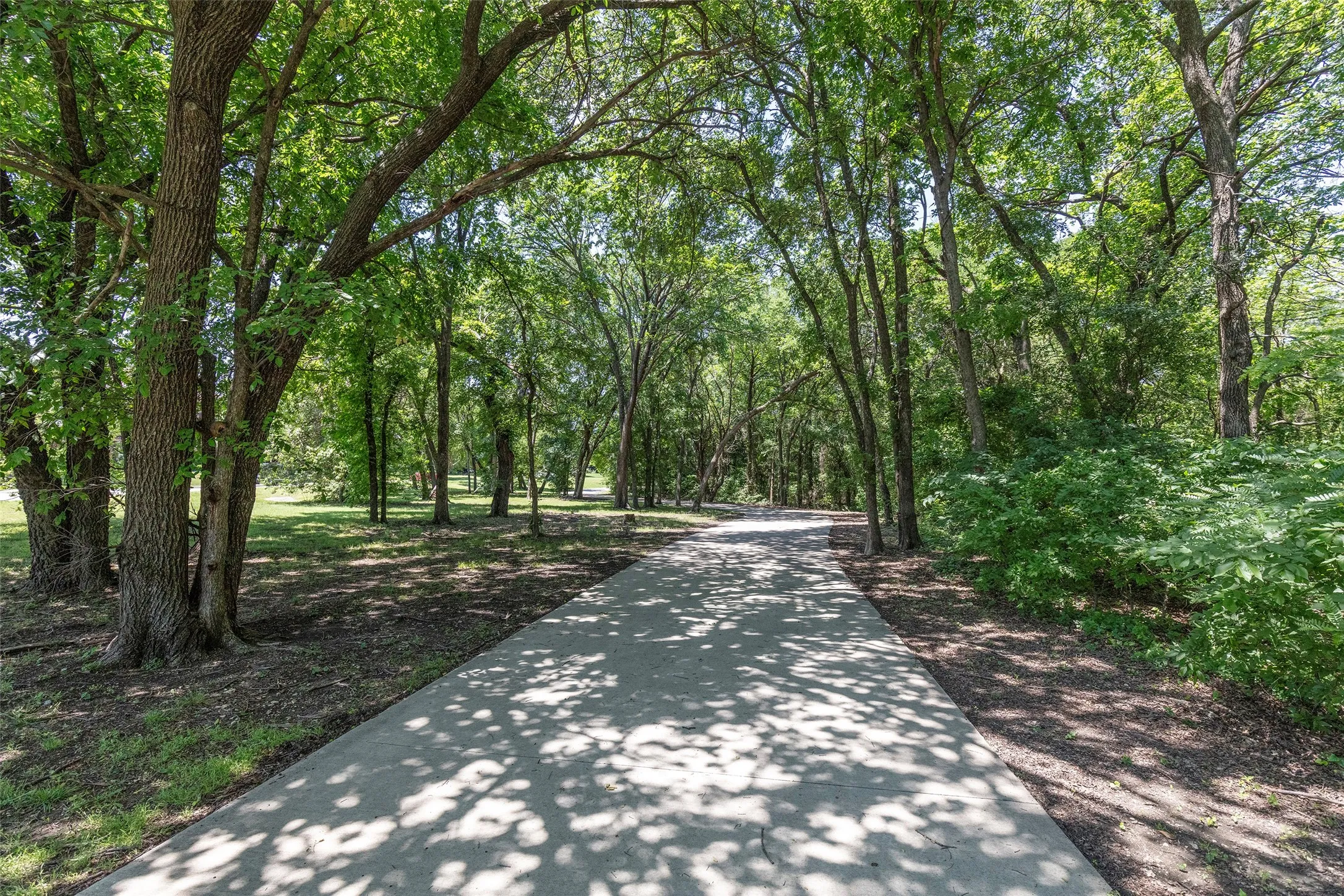 Step outside and enjoy peaceful walks beneath a canopy of mature trees along scenic community paths.