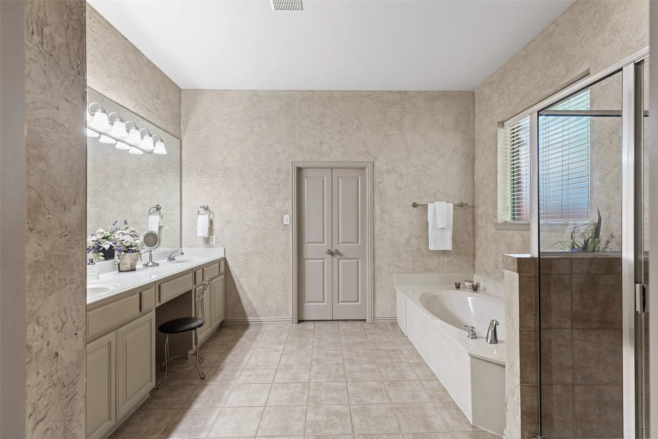 Unwind in the jetted tub or refresh in the separate glass-enclosed shower, all just steps from the primary bedroom.