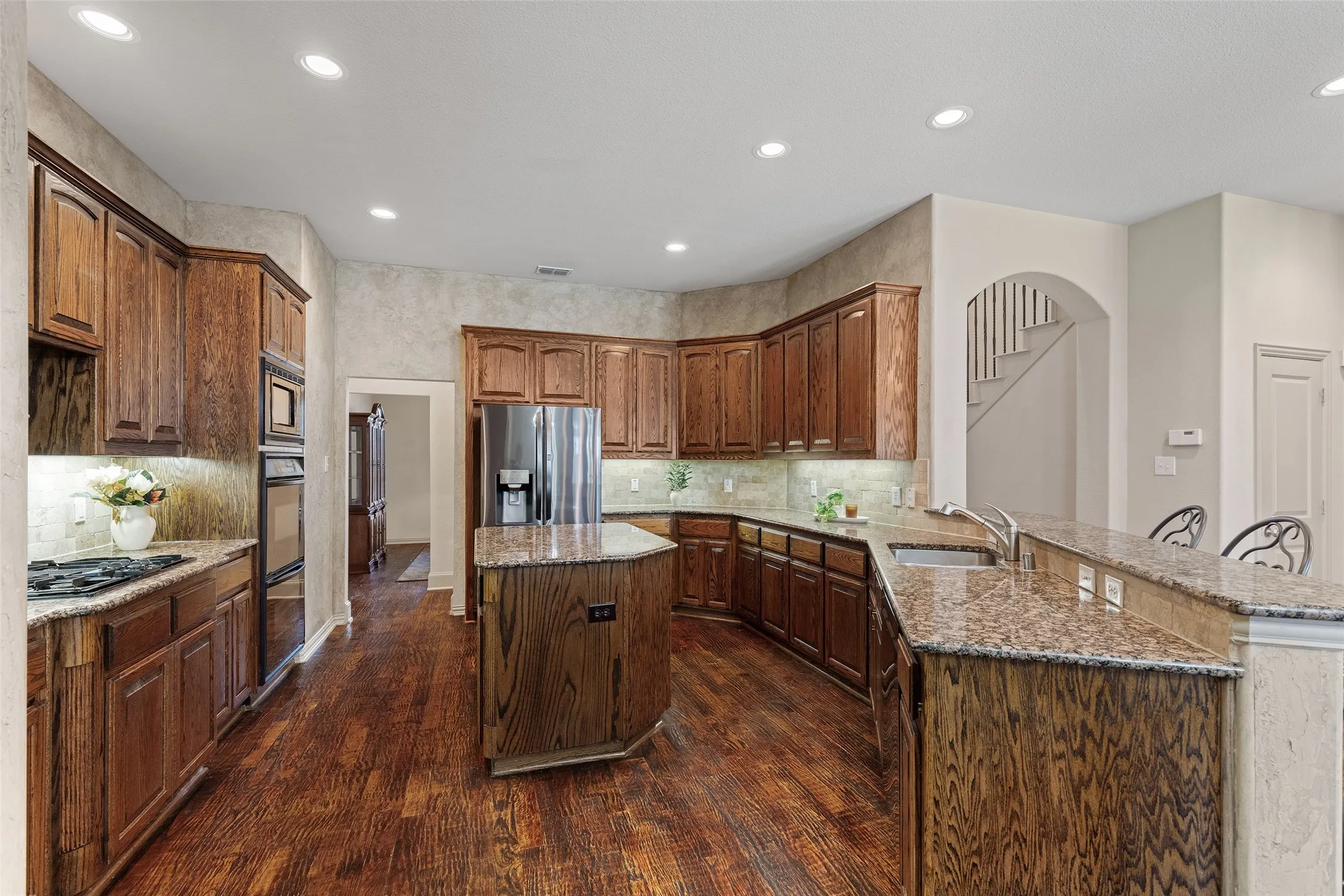 Stainless steel appliances, abundant storage, and a center island keep everything within easy reach.