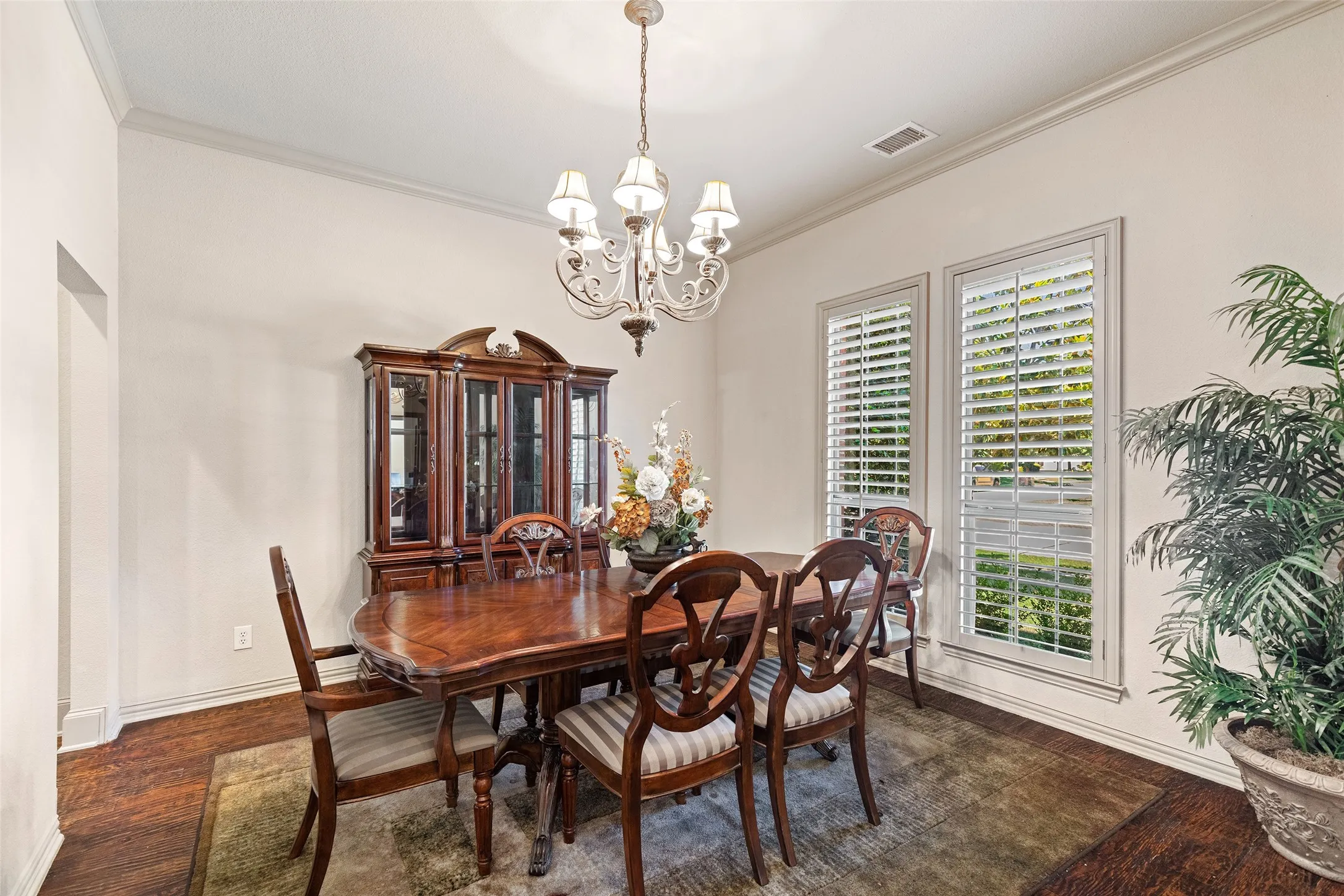 Just beyond the foyer, the formal dining room invites memorable dinners beneath a graceful chandelier.