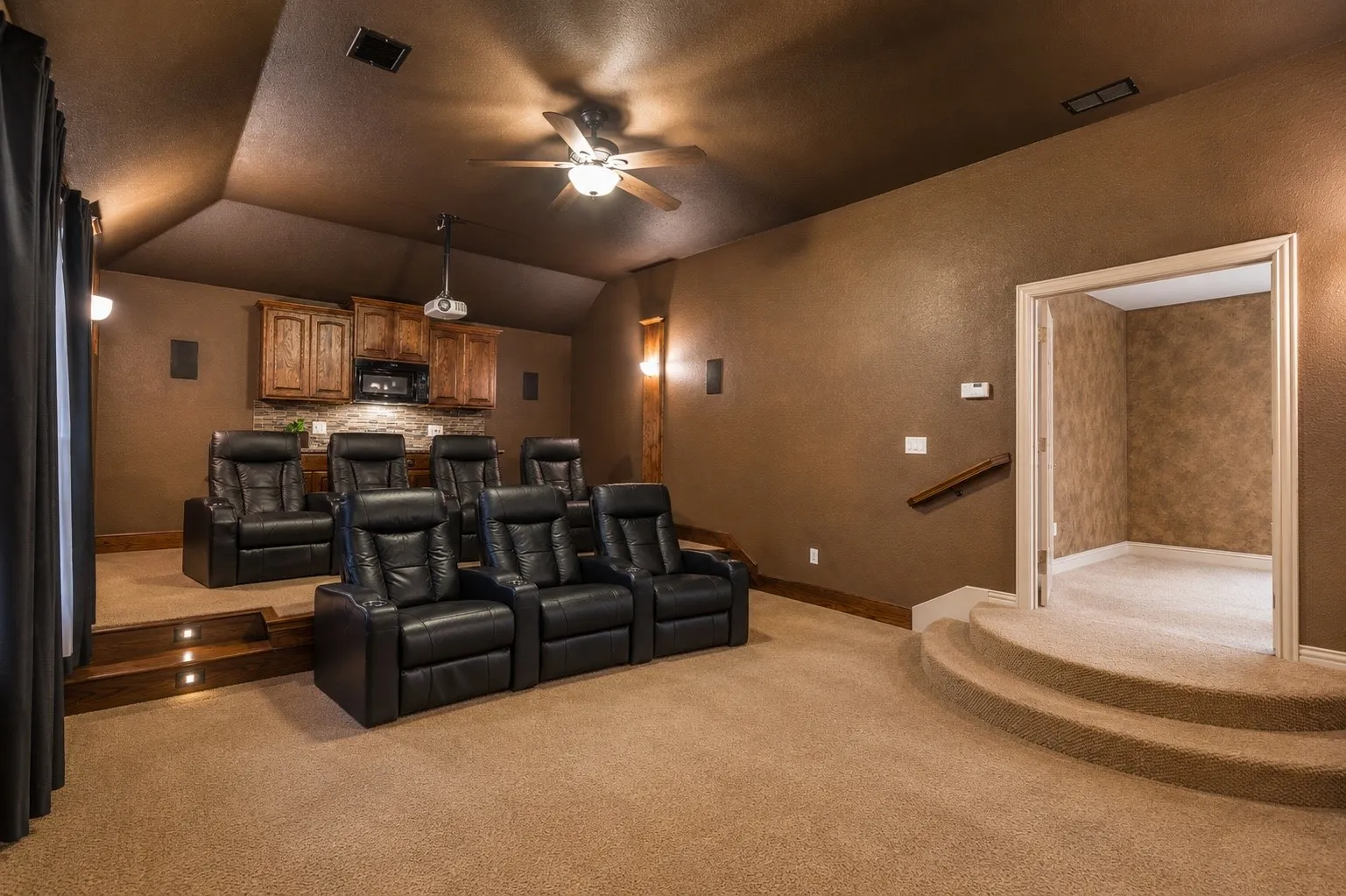 Stadium-style seating, surround sound, and a built-in refreshment station turn movie nights into a true cinematic experience.