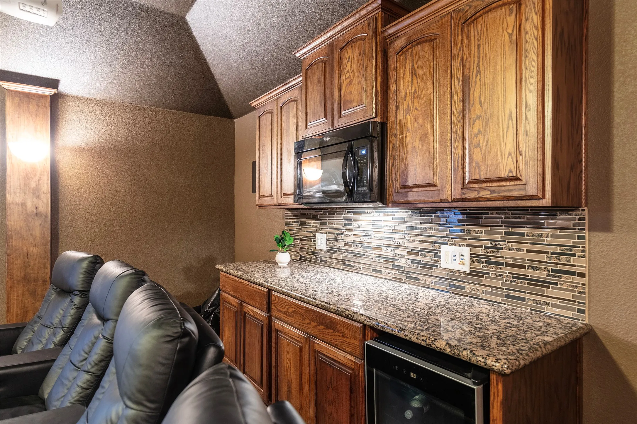 Tiered seating and a convenient refreshment bar complete this exceptional entertainment space.