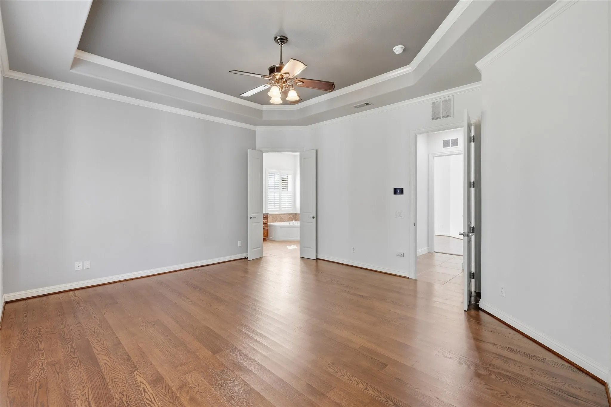 Tray ceilings detail the primary bedroom.