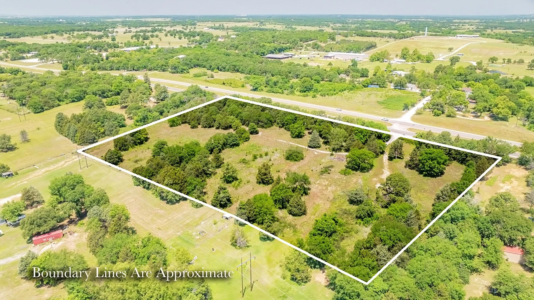 Expansive land parcel featuring a mix of mature trees and open clearings