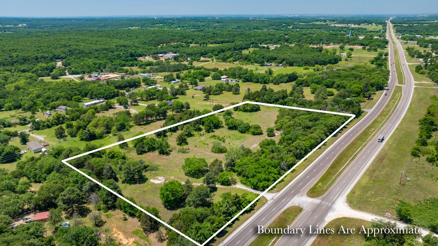Expansive parcel featuring a mix of open fields and mature tree coverage