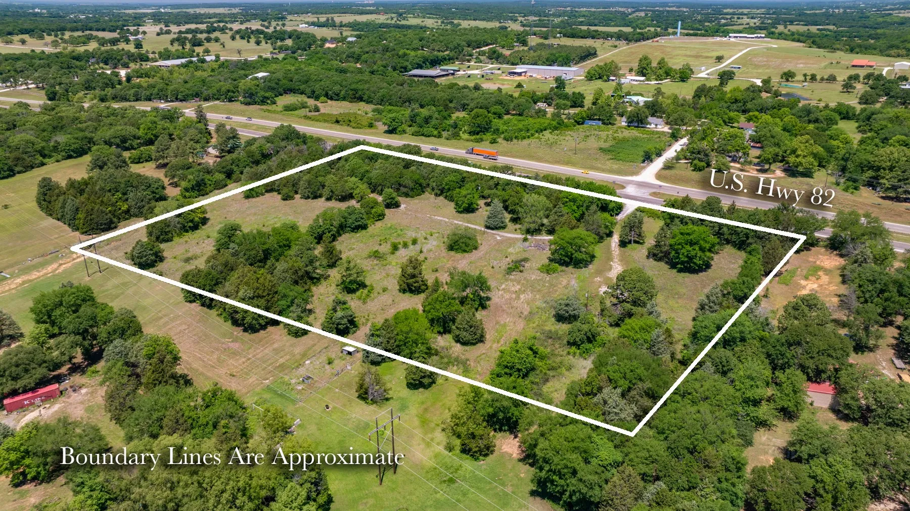 Expansive wooded acreage with a cleared pasture area