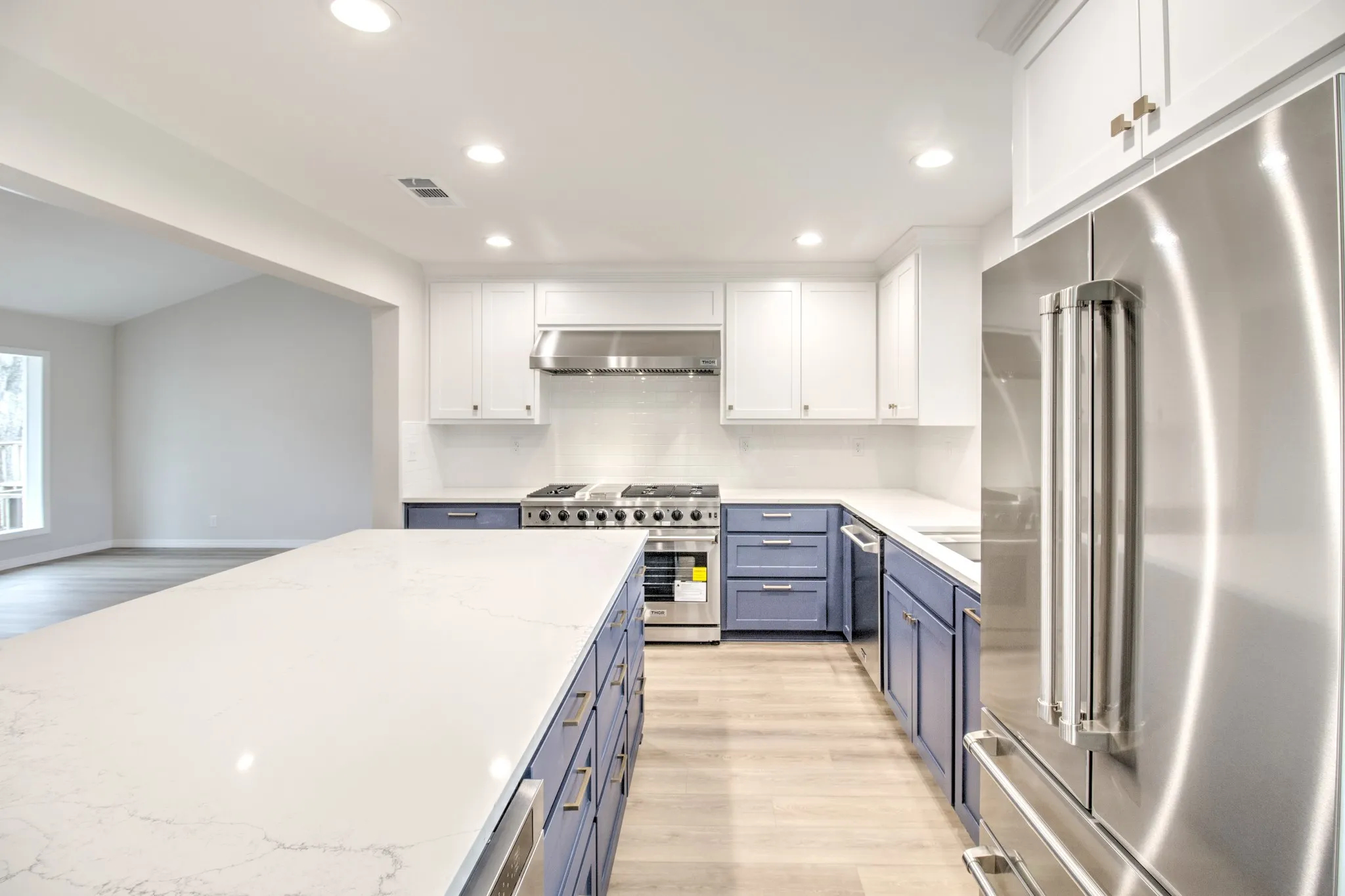 Your Dream Kitchen awaits, with brand new cabinets, fixtures, cabinet hardware, Quartz countertops, tile backsplash, and Stainless Steel Thor Appliances.