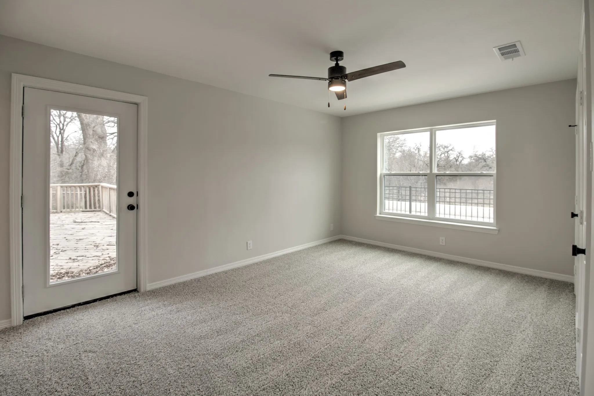 Large Bedroom with two walk in closets, ensuite bathroom, with direct access to the back patio allowing it to be the perfect secondary master.