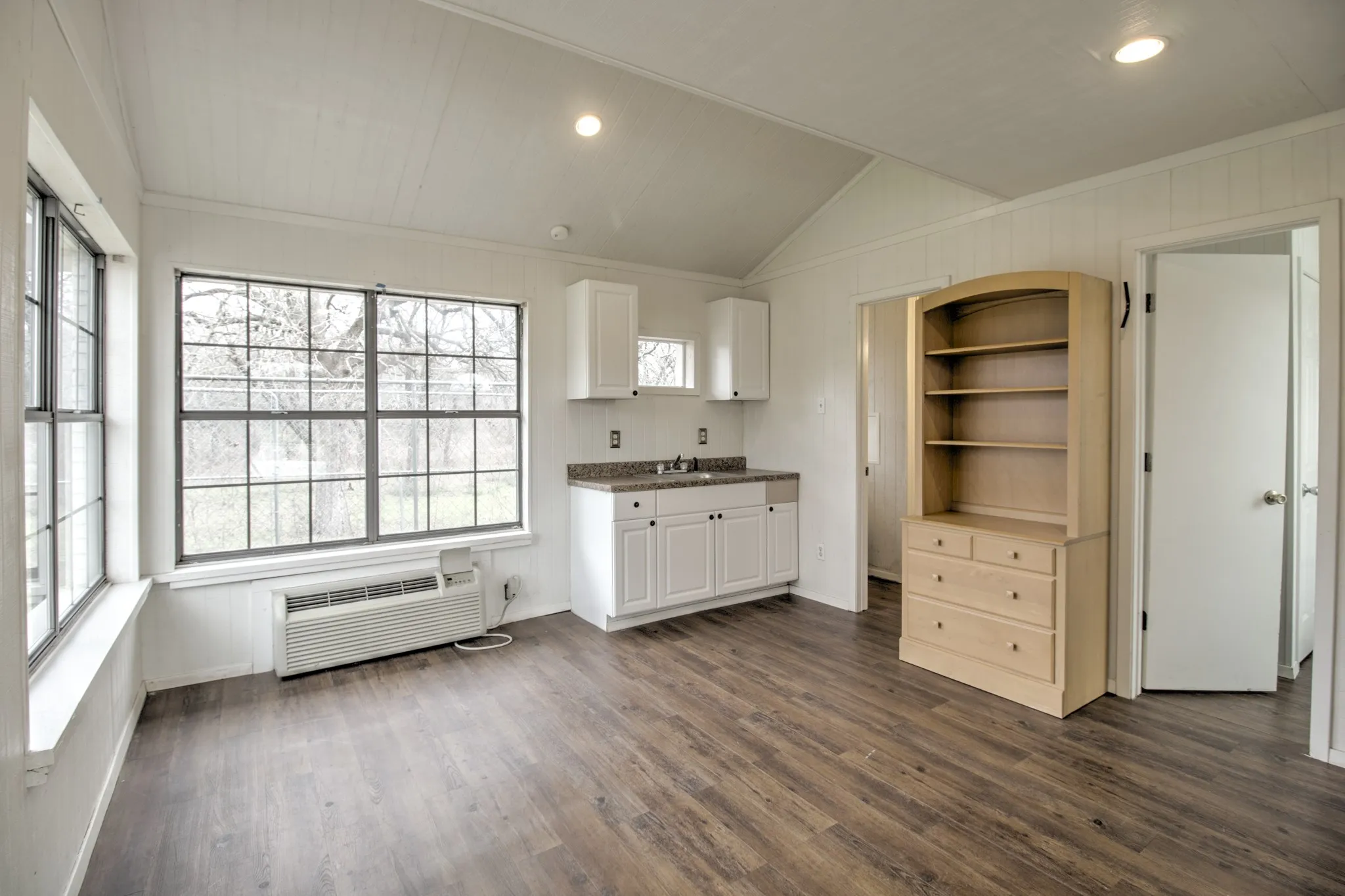 Pool House with AC. sink, bathroom with shower, and storage, perfect for getting out of the heat.